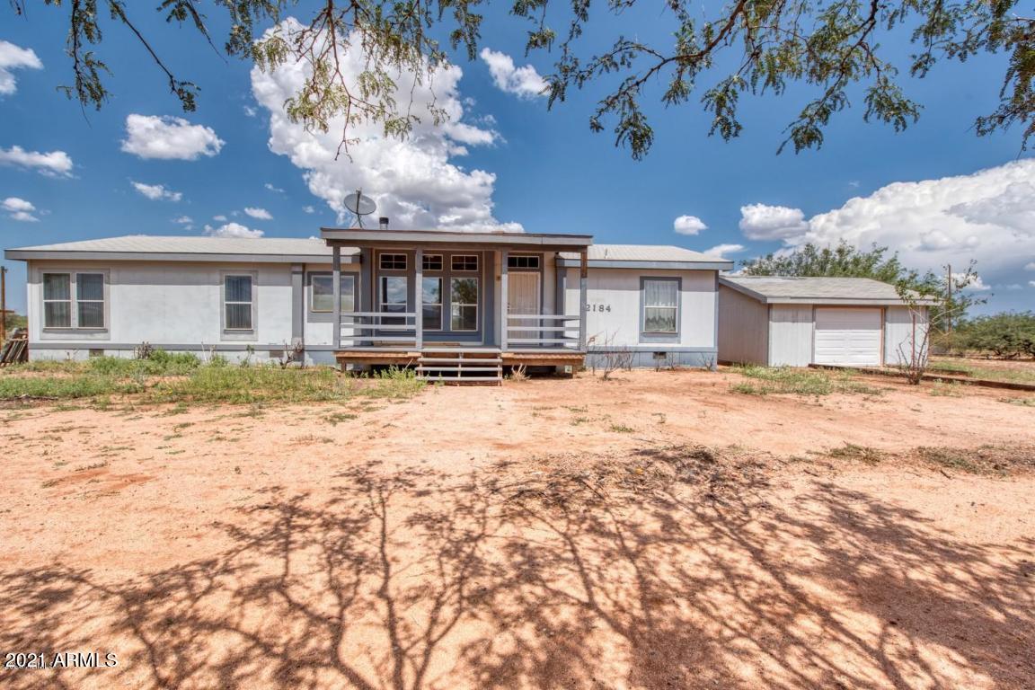 Looking for country living but want to be close to town with gorgeous mountain views?? Then you have to come check out this spacious 4 bedroom 2 bath home on 6 acres!! It has a huge Kitchen with lots of cabinets and counter space. Split floor plan, living room and family room with wood burning fireplace. Has both evap and AC units. Detached garage and huge hay storage barn. HOME SOLD AS IS.