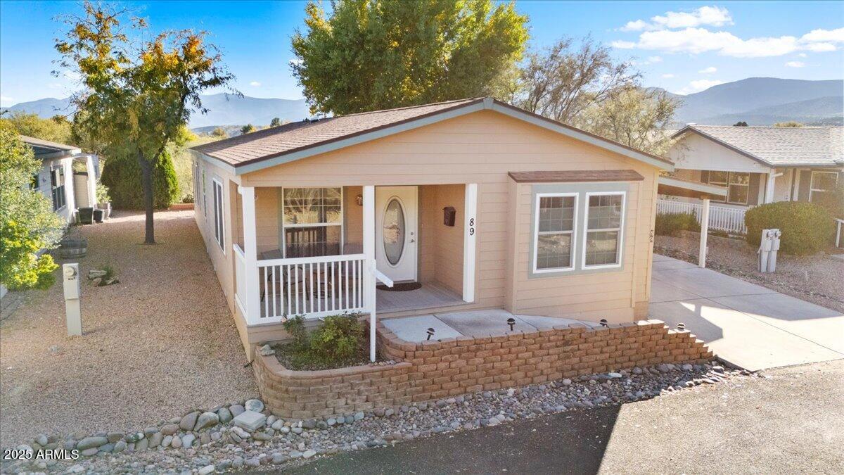 Original owner pride shines throughout this wonderfully maintained 2007 Redmond manufactured home, located in The Willows—a desirable 55+ leased-land community. Offering 1,568 sq. ft. of comfortable living space, this home features 3 bedrooms and 2 full bathrooms in a bright, open floor plan. The spacious primary suite includes a walk-in closet, dual vanity sinks, a separate soaking tub, and a new step-in shower (installed just 4 months ago) complete with a sitting bench. Vaulted ceilings and newer windows with Levolor blinds fill the home with natural light, enhancing the warm and inviting atmosphere. Enjoy both casual and formal dining options with a breakfast bar and dedicated dining space. Please See Continued.... Continued.... The convenient laundry area connects to the kitchen, guest bath, and back entrance for easy access. Relax on the front porch while taking in views of mature Mesquite trees and the open space adjoining the community clubhouse. Additional features include an attached 2-car tandem carport and a 12' x 12' storage shed, offering plenty of room for tools, projects, or extra belongings. Behind the shed, facing south, a private patio provides a cozy space with a touch of mountain views. The Willows subdivision has a clubhouse, larger outside area including a tennis court, (sometimes used for pickleball), sitting areas, mature Mesquite Trees and walking paths. Buyer to obtain park pre-approval during inspection period.