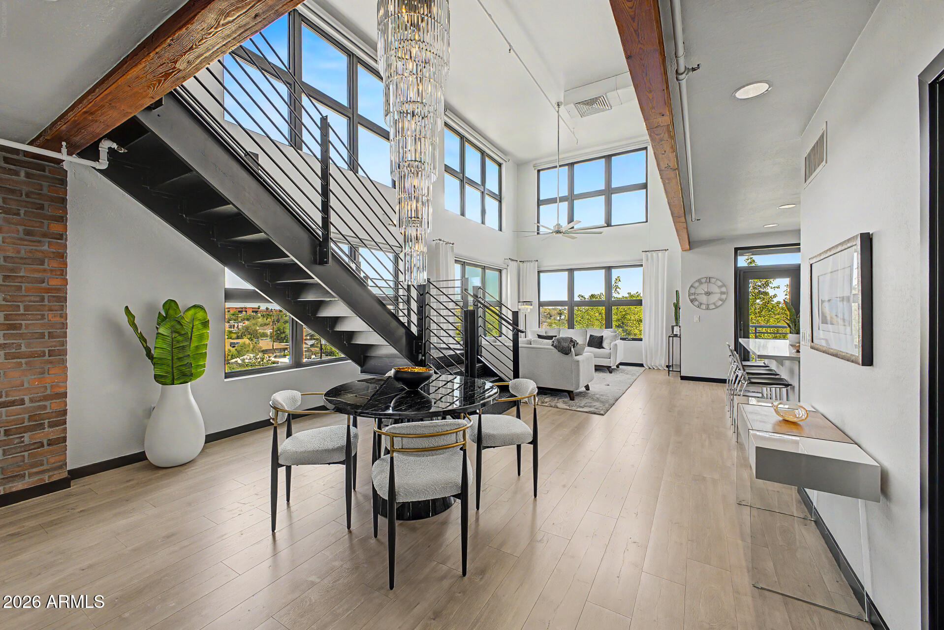 Experience refined urban luxury in this exquisitely upgraded premier penthouse corner residence offering 2 bedrooms, 2 baths, and 1,728 square feet in the heart of Phoenix. Blending sophisticated design with modern comfort, this exceptional condo showcases curated high-end finishes, dramatic architectural details, and breathtaking ''million-dollar'' views of both the city skyline and surrounding mountains from two private outdoor terraces designed for elevated city living. Thoughtfully reimagined with extensive recent enhancements, the residence features a custom illuminated wine wall, designer lighting throughout, a fully updated kitchen with premium appliances, restored countertops, refinished architectural beams, textured and freshly painted walls, and beautifully refreshed bathrooms with new mirrors, fixtures, and custom hardware. Flooring has been repaired and partially replaced, enhancing both continuity and comfort while preserving the home's architectural character. Every detail was carefully considered, from dimmable ambient lighting and upgraded door hardware to integrated TV wiring and enhanced outdoor entertaining spaces. The rooftop terrace is a true showpiece, offering automated ambient lighting, built-in speakers, and sweeping panoramic views that create an unforgettable setting for entertaining or relaxing above the city lights. Exceptionally quiet due to its premier corner positioning, the residence offers a rare sense of privacy in the heart of the city.
Perfectly positioned near premier dining, entertainment, sporting venues, and the best of downtown Phoenix, this residence delivers an exceptional blend of luxury, style, and metropolitan convenience.