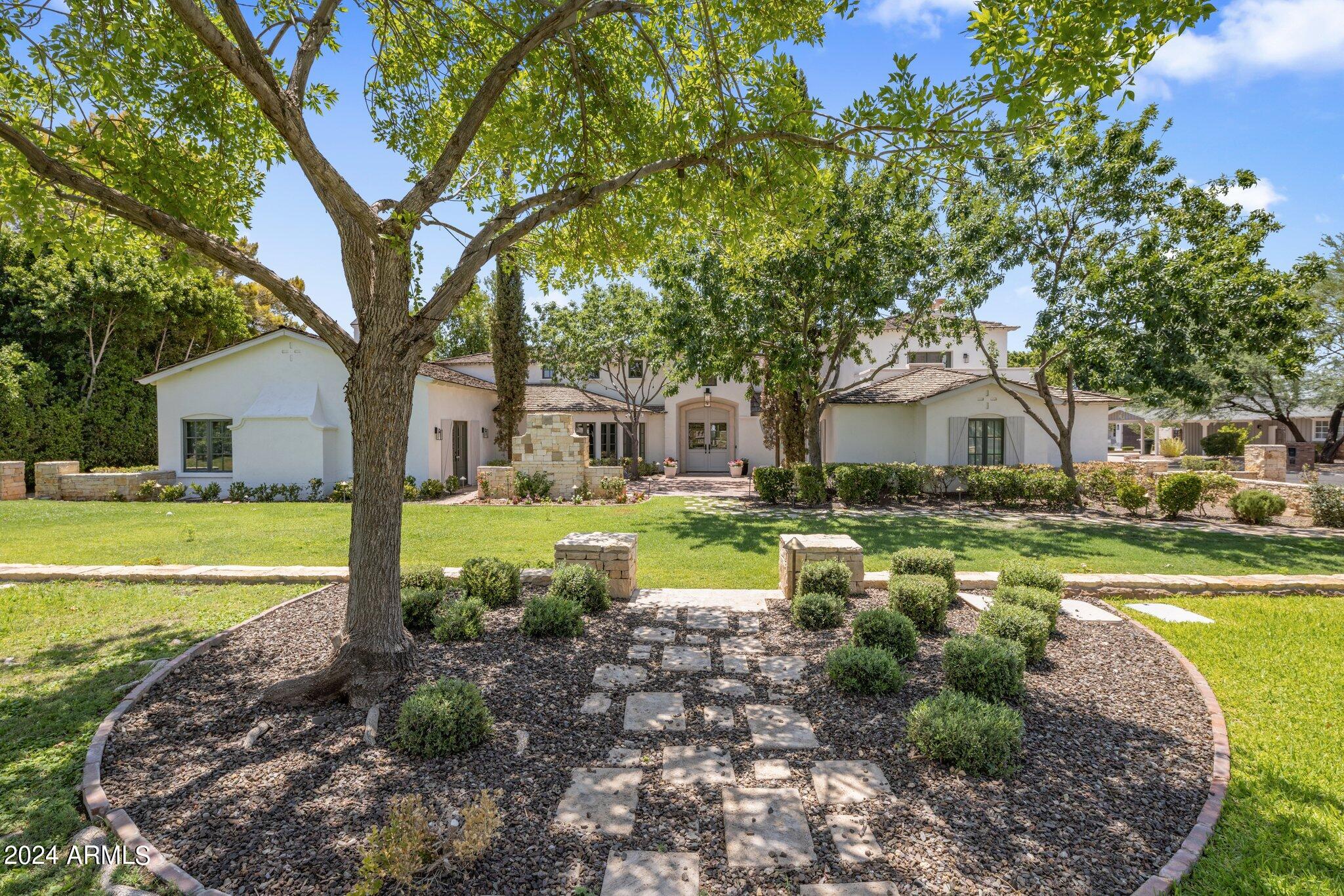 A true Arcadia Proper icon, this exclusive property was once featured in Dream Homes of the Southwest. Redesigned by Candalaria & renovated by Nance Construction in 2003, this notable home was thoughtfully designed with historic charm & subtle luxury. The expansive lot features impressive Camelback Mtn views from the rolling grassy entry courtyard to the backyard pergola to the gorgeous Primary Suite. This timeless home offers 5 bedrooms, 4.5 baths plus an Office. European style front brick terrace & double doors invite you into the grand sun filled Foyer. The vaulted chef's Kitchen comes fully equipped & offers more Camelback views from the central island & the most beautiful Breakfast Room. Entertain in the formal Dining Room with custom millwork & cabinetry, the sizable vaulted Family Room with front courtyard access or the perfectly serene Living Room w gas fireplace. The impressive backyard transcends you with a tiled salt water pool, private white pergola, outdoor Kitchen with built-in gas BBQ, covered patio w porch swing, outdoor shower, landscaped surround & room for your own vegetable garden. The Primary Suite is charming with a gas fireplace & private balcony for coffee with views. The Primary Bathroom features a walk-in marble shower, brass fixtures, his & hers water closets, two separate marble vanities, a claw-foot soaking tub & a custom walk-in closet. Laundry Room with custom cabinetry perfect for storage. Brand new wide plank Royal Oak floors throughout elevate each space of this home & add an element of functionality. New Trane units, water heaters, custom Emtek hardware, custom interior & exterior lighting, updated bathrooms, fresh paint, 2 wine fridges, Scotsman ice maker, Electrolux washer/dryer, salt water pool heater & pump, salt chlorinator, Lutron Smart Home technology, frontyard landscaping & basketball hoop. Side entry garages offer even more storage. Your dream home awaits.
