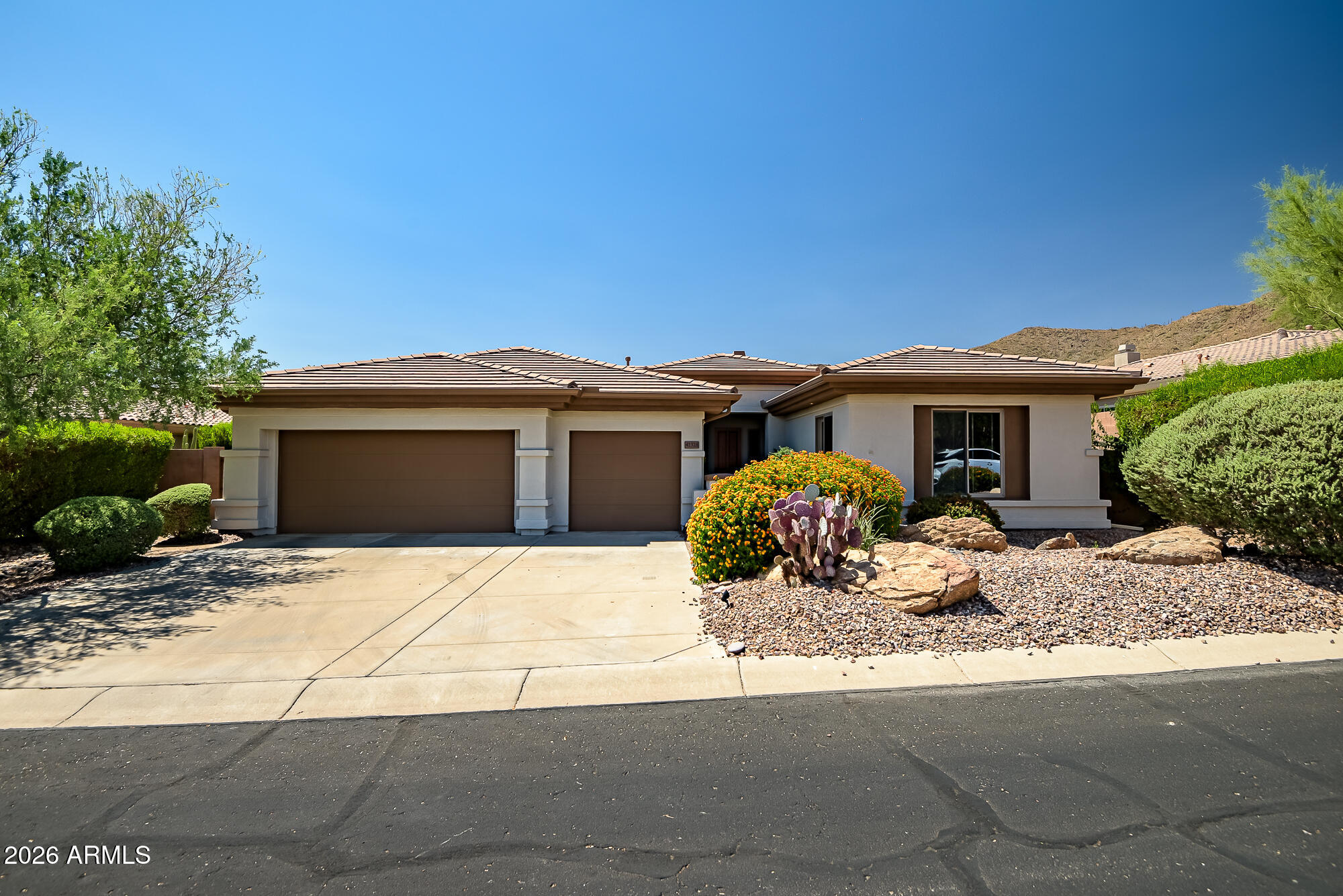 Stunning Anthem Country Club home behind a private courtyard gate! Chef's kitchen features a raised island with stainless appliances, perfect for entertaining. Extended primary suite with double sinks; 2nd bedroom has it's own guest bath. Art room with double french doors & cabinets. Designer glass art in bathrooms. AC 2021, water heater 2025, separate RO systems in kitchen and primary and casita baths, water softener, fire sprinklers, Andersen doors and windows. Extended 3-car garage with service door. Detached casita with mini-split, ideal for guests or office. Backyard retreat: fireplace with gas hookup, mechanical shaded patio awning, river rock, 3 mature saguaro and breathtaking Daisy Mountain views. Enjoy Anthem Country Club amenities, such as golf, tennis, pools, pickleball, fitness, dining and so many social events - you'll never be bored!