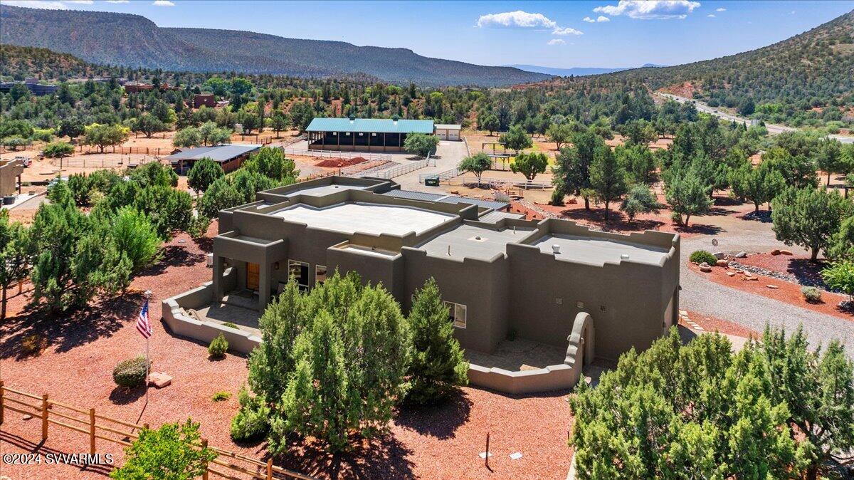 Gorgeous 7-Acre Horse Property in Sedona. Welcome to this stunning gated equestrian estate, set on 7 acres of fully fenced and cross-fenced land. This exceptional property offers a beautifully designed 3-bedroom, 3-bath home, complete with an office and an open floor plan. Richly stained Alder wood doors and cabinets, paired with granite countertops, add an elegant touch throughout. Step outside to an inviting patio perfect for outdoor entertaining, and rest easy knowing the home comes equipped with a whole-home backup generator. Equestrian facilities include an impressive 8,000 sq. ft. covered arena featuring four 12x12 stalls, a bathroom with shower, tack room, and an interior wash bay with hot and cold water. Additionally, there's a separate stable with two 12x16 stalls, rubber flooring, a wash rack, bathroom, tack room, and hay storage. The five pastures and six stalls are outfitted with non-freeze automatic waterers, ensuring your horses' comfort year-round.For your equipment, there is a detached four-car garage offering ample storage. This one-of-a-kind Sedona property is perfect for horse enthusiasts and offers far more than can be listed hereplease refer to the attached documents for a complete list of features.Don't miss the opportunity to own this remarkable equestrian estate!