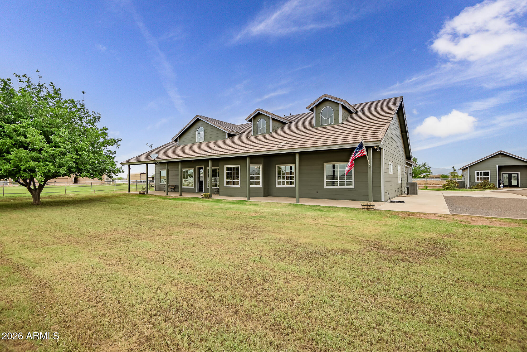 Experience refined country living on this immaculate 2.3 acre horse property with mountain views and exceptional detail throughout. The main residence offers just under 3,000 sqft of thoughtfully designed living, complemented by a fully detached guest house with 476 sqft, kitchen, bedroom, and bath. Inside the main home, quality craftsmanship and thoughtful design are evident with wood flooring, massive beams, an upgraded kitchen with stainless appliances, raised dishwasher, and a walk-in pantry. Soaring ceilings and natural light create an open, inviting flow. Designed for both lifestyle and function with paid solar, private well, flood irrigation, 5-car garage, and a complete horse setup including lush pasture, stalls, and wash rack. See the full list of upgrades and features in docutab.