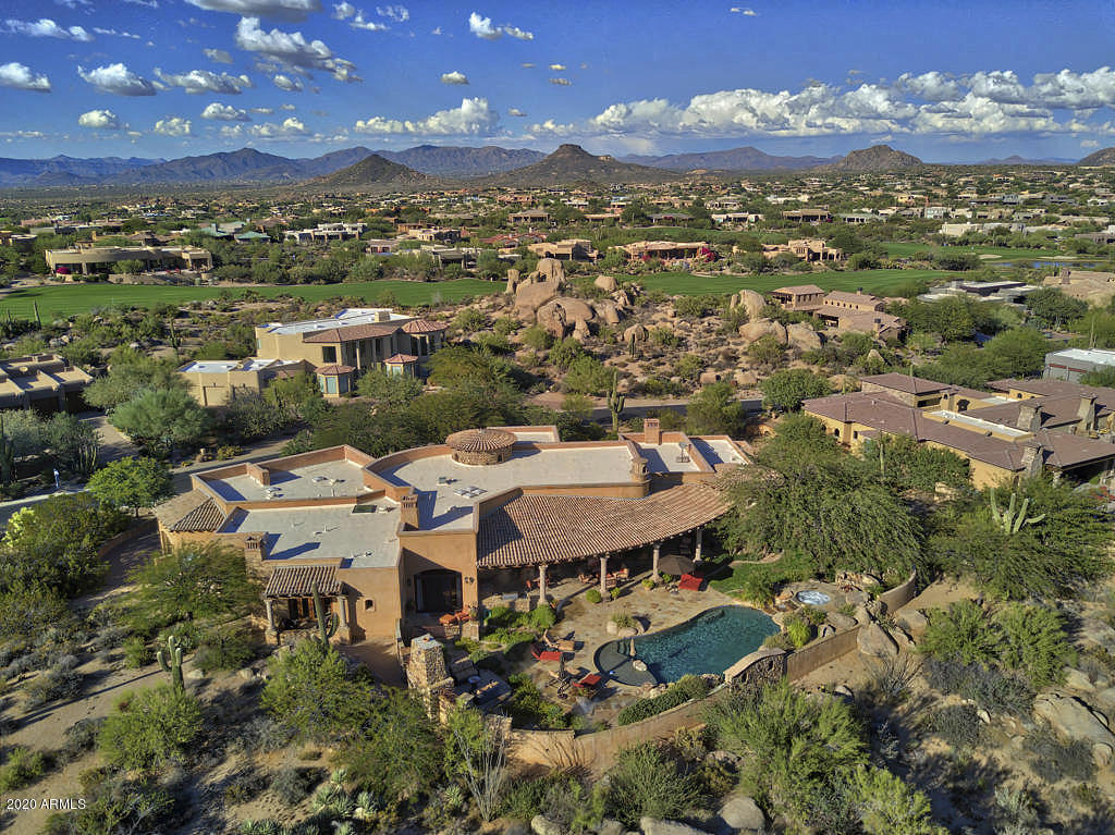 Hand-crafted home in Troon North's premier enclave, Pinnacle Canyon * Peerless home featuring high quality construction and spacious living spaces that are perfect for entertaining * Panoramic views of Troon Mountain and the McDowell Mountains * Massive master suite includes a sitting area with fireplace plus 3 ensuites for guests * Architectural details include the use of natural stone, wood beams, custom wood framed windows and unique ceiling details * Other details include a custom temperature controlled 250+ bottle wine cabinet, easy to use smart technology for audio/video, lighting, pool equipment and integrated misting system * Six total fireplaces * The outdoor living area includes over 1,300 square feet with a south-facing solar orientation for warm winter sun *