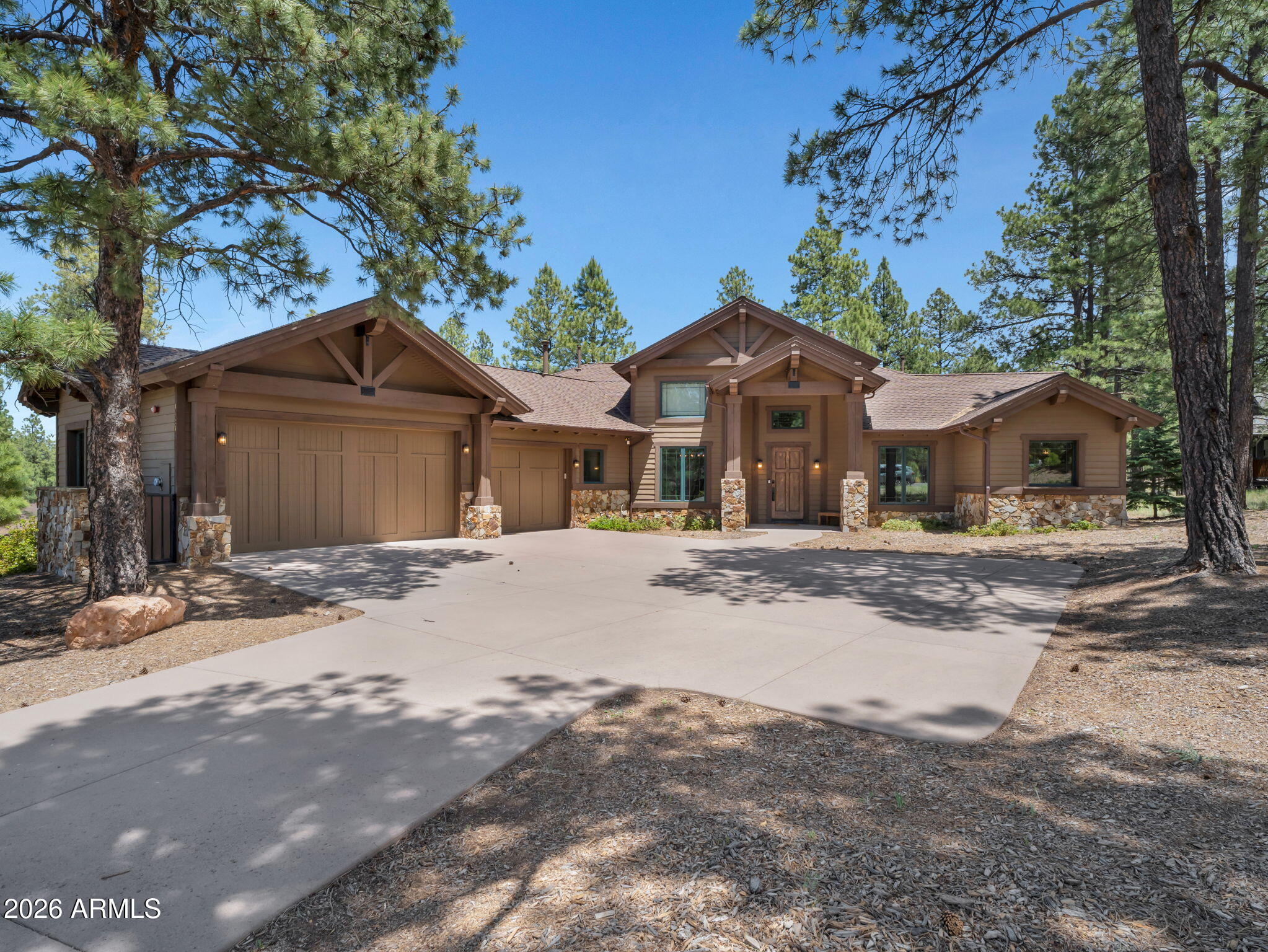 Nestled on a quiet private street within the prestigious community of Pine Canyon, this stunning single-level mountain retreat offers 4 bedrooms, 3.5 bathrooms, and 2,983 square feet of thoughtfully designed living space surrounded by towering Ponderosa Pines. Blending timeless mountain architecture with elevated finishes, the home delivers both warmth and sophistication in every detail. The inviting great room is anchored by a dramatic floor-to-ceiling stone fireplace, creating the perfect gathering space for cozy evenings and effortless entertaining. Just beyond, the gourmet kitchen is a chef's dream, featuring a custom stone-accented island, double ovens, a 6-burner range with griddle, warming drawer, and abundant custom cabinetry. A spacious butler's pantry with an oversized wine fridge provides exceptional storage and entertaining convenience, while an additional wet bar with its own wine refrigerator adds another touch of luxury.
Designed for seamless indoor-outdoor living, the primary suite offers private access to the back deck and serves as a peaceful sanctuary. The spa-inspired primary bath features separated dual vanities, a jacuzzi soaking tub, walk-in shower, and generous walk-in closet, creating a true retreat experience.
Complete with a desirable 3-car garage and tucked within one of Pine Canyon's most serene settings, this exceptional residence captures the essence of refined mountain living.