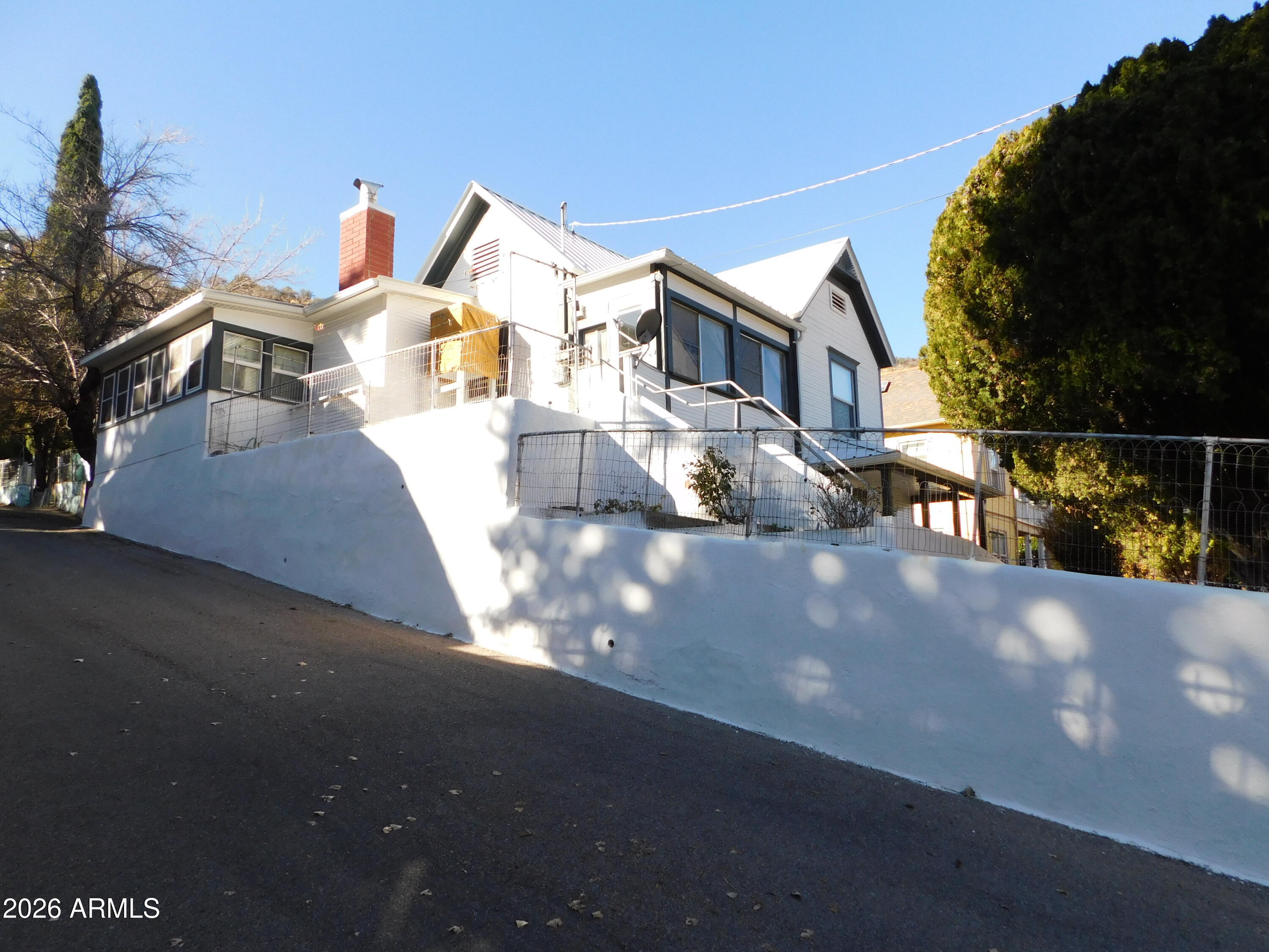 Currently a single-family home, originally two separate residences. Easily convertible back into two 2-bedroom apartments by closing the interior stairwell. Step Back in Time with This 1905 Bisbee Beauty with Views that'll Steal Your Heart! This exceptional SOLID historic 1905 two-story residence, located in the heart of Old Bisbee, offers approximately 2,550 square feet of versatile living space with superb panoramic views & privacy. A key feature of this property is its excellent potential to function as two separate homes or apartments. The second floor can be easily closed off to create an independent unit with 2+ bedrooms, 1 bathroom, and a full kitchen, while the lower floor provides its own 2-3 bedrooms /1 bathroom with space for a full kitchen - making it ideal for multi-generation living, extended family, or generating rental income in this popular tourist destination. If used as a single-family home, the space is endless.
Why You'll Fall Head Over Heels:

4+ Bedrooms & 2 Bathrooms: Plenty of space for family, friends, or that eccentric artist phase you've been dreaming about.
Full-size attic. Large closets and multiple pantry spaces. Several main entrances to choose from, and to help section off the floors if considering turning it into two homes/apartments. PLENTY of parking for those fabulous BBQ's!

Versatile Vibes: Transform the second floor into a separate apartment with its own 2 beds, 1 bath, and kitchen - rental income or in-law suite! Close it off, and voila: two independent homes under one roof. Perfect for multigenerational living or Airbnb gold in touristy Bisbee.

Bonus Fun Zones: A dedicated indoor workshop/creative space for your DIY dreams, and a game room(or extra bedroom/office/2nd living room) that's begging for ping-pong/pool tournaments, movie nights, or whatever shenanigans you cook up.

Outdoor Oasis: Huge front yard - 3-car carport and covered patio with a romantic swing overlooking the mountains and the beautiful colors of Old Bisbee. That's just the start of the magic at this charming 1905 two-story gem - a historic home that's equal parts cozy retreat, adventure pad, and income opportunity! Nestled close to downtown so you or your guests can walk to all that Old Bisbee has to offer without having to get into your car.

This amazing stunner isn't just a house, but a solid foundation for all of your future needs... and nestled within walking distance to downtown, where the vibes are vibrant, and you can enjoy Bisbee's artsy, eccentric spirit.

Whether you're a history buff, a view junkie, or a savvy investor, this property screams "adventure awaits!"

Welcome Home!