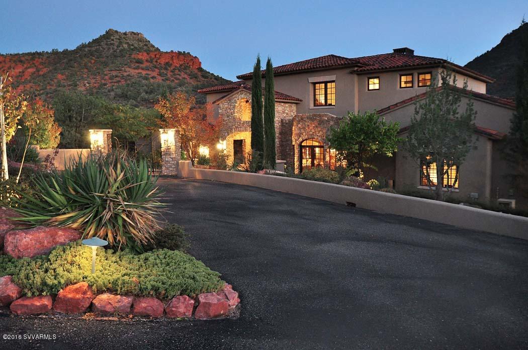 It’s the ultimate marriage of luxurious gracious living and the elemental connection with Nature. When only the very best will do, come experience this majestic estate situated on a pristine section of Oak Creek amidst abundant sycamore trees; 6.9 verdant acres bordering U.S. National Forest on two sides. This home has it all. Here, only ten minutes from great restaurants, galleries, festivals, & golfing in town, you are surrounded by thousands of acres of National Forest to explore and a long, crystal clear stretch of Oak Creek with waterfalls and a lagoon in which to play. Or, you may simply decide to meditate on the serenity and beauty of this sanctuary from the stresses of the outside world. Then again, you may want to savor the phenomenal appointments of this grand residence(See MORE)
Or throw a fabulous indoor/outdoor party on the expansive lawn and pavilion next to the creek. With all of the magic of the nature and green on the banks of scenic Oak Creek along with beautiful lawns and gardens, this property is as much about the outside as it is about the warmth and comfort of the inside, with access to hiking trails in every direction and direct access to the U.S. National Forest. This is a majestic estate property with a welcoming, elegant home situated in exclusive Eagle Mountain Ranch, surrounded by gorgeous landscaping on Oak Creek. What you'll find here is a private and quiet family compound that is uniquely special. Upon entering this extraordinary home one admires the magnificent grand entry foyer and living room, and its expanse of doors and windows that connects us with the outdoor terrace and lounge areas. The center and right wing of this house are dedicated to daytime use, the heart of which are the generous living and dining areas, and the spacious and bright gourmet kitchen and family areas, all presented with warmth, style and beauty. The covered terrace, seating areas and outdoor kitchen flank this wing of the home and overlook the immaculate backyard and the Oak Creek wonderland. Back inside the house, there's the ideal executive office and the left wing, which features the beautiful master bedroom, consisting of: The bedroom, the stunning sitting area, the master bath, the master closet and the exercise room. The second level boasts the three gorgeous guest bedrooms, all with ensuite bathrooms and glorious views. This elegant and personal home is ideal for its quiet creek front and red rock view setting along with being the perfect home for entertaining. It's decorated with natural stone and warm tones, with excellent spaces for artwork and special personal items, all of which add to its generous livability. Abundant windows, courtyards and terraces, gardens with stone walls and more combine to make this home a unique jewel in Sedona.