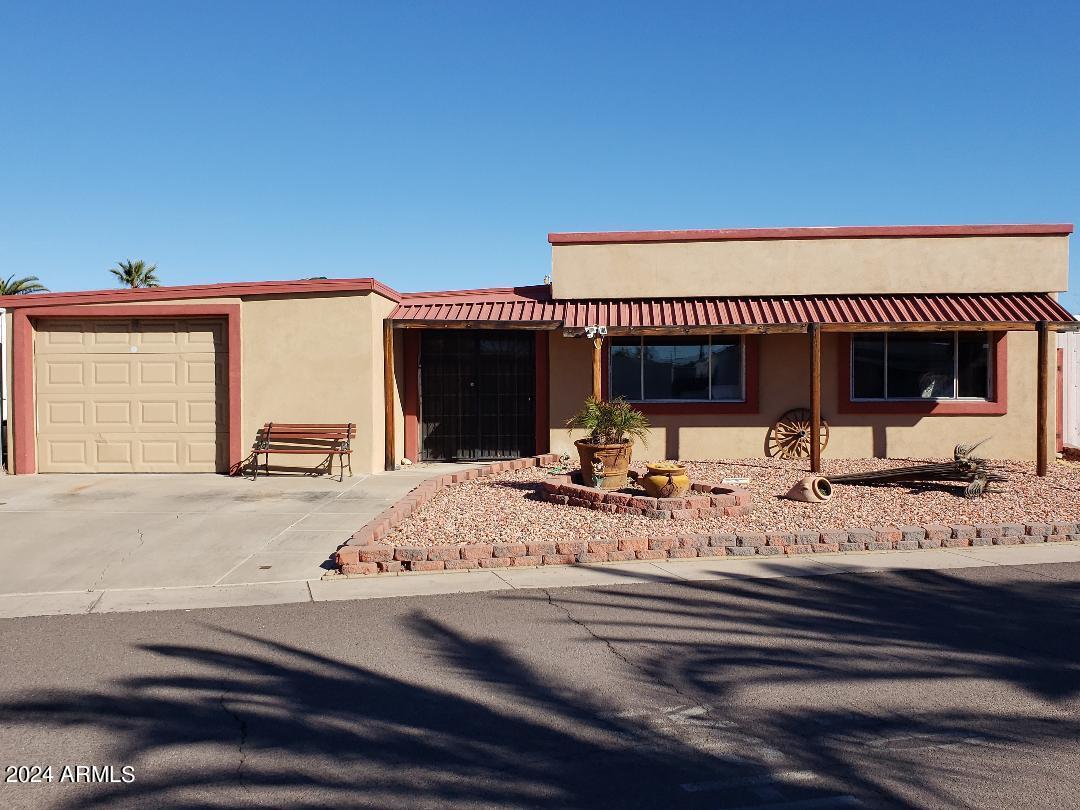 ON LEASED LAND. Dont miss out on this 2 bedroom 1.75 bath manufactured home with a 2 car tandem garage. Remodeled inside with drywall throughout, both bathrooms remodeled. Exquisitely accented with cedar throughout. Both bedrooms have walk in closets. Arizona room is enclosed adding extra square footage(not included in 1344) Easy maintenance fully fenced yard with extra storage unit. Located in a 55 plus age restricted gated community. Community is in the process of going thru major updating including pickleball, new pool, spa and much more.