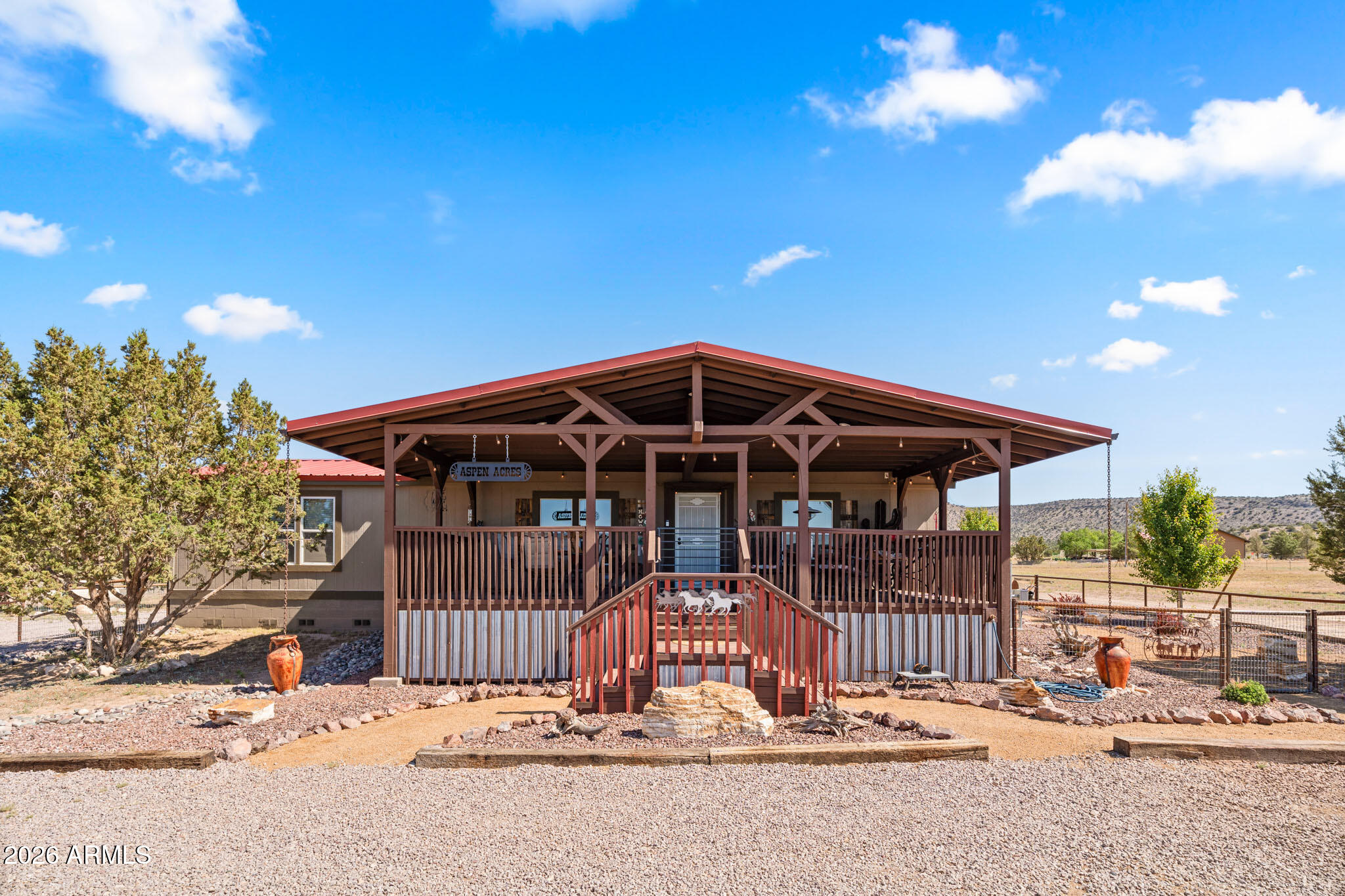 Experience the best of Arizona ranch living on this extensively upgraded and move-in ready property in Paulden. With no HOA and direct access to miles of state land from your gate, this property offers the freedom, privacy, and wide-open spaces that define country living.

The beautifully remodeled 3-bedroom, 2-bathroom home combines warm western character with modern comfort. Interior improvements include updated flooring, custom wood accents, upgraded cabinetry, modern fixtures, and inviting living spaces designed for everyday enjoyment. An oversized covered deck provides the perfect place to relax and take in panoramic mountain views, spectacular Arizona sunsets, and peaceful mornings.

Outside, the thoughtfully developed property offers exceptional versatility. Multiple fenced area covered shelters, storage buildings, a barn, and a spacious 120' x 220' sand arena create endless opportunities for ranch living, recreation, livestock, equipment storage, hobbies, and future projects.

The detached garage and workshop provide outstanding flexibility for equipment, recreational vehicles, crafts, woodworking, storage, or home-based pursuits.

Significant infrastructure improvements have already been completed, including exterior upgrades, HVAC updates, windows, roofing components, landscaping, lighting, and numerous permitted additions. Every detail reflects pride of ownership and careful planning.

Whether you're seeking a full-time residence, recreational retreat, hobby ranch, or simply a place to enjoy the Arizona lifestyle, this property delivers a rare combination of comfort, functionality, character, and freedom.

From the custom outdoor gathering areas and western-inspired touches to the mature landscaping and thoughtfully planned layout, this property reflects pride of ownership at every turn.

Nothing left to build. Nothing left to finish. Simply move in, settle in, and enjoy the beauty, freedom, and tranquility of Northern Arizona ranch living.