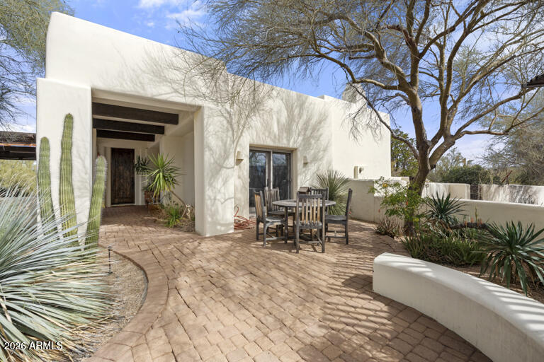 Nestled in the serene desert of North Scottsdale on  9.7 private acres this exceptional estate offers privacy, space, and breathtaking views.  The single-level main residence features 2 spacious bedrooms and 2 beautifully appointed baths, designed with an open-concept great room layout ideal for effortless living and entertaining. A large gourmet kitchen anchors the home with , premium appliances, and seamless flow into the dining and living areas. Sliding glass doors frame stunning desert views and offer great indoor outdoor living. Step outside to a beautiful pool  with built in BBQ. A charming, separate 2-bed 2-bath guest house offers privacy and comfort for visitors and 2 car garage A separate detached 2 car garage offers automatic doors and a spacious workshop with gun safe and restroom. Free standing storage building  conveys as-is.