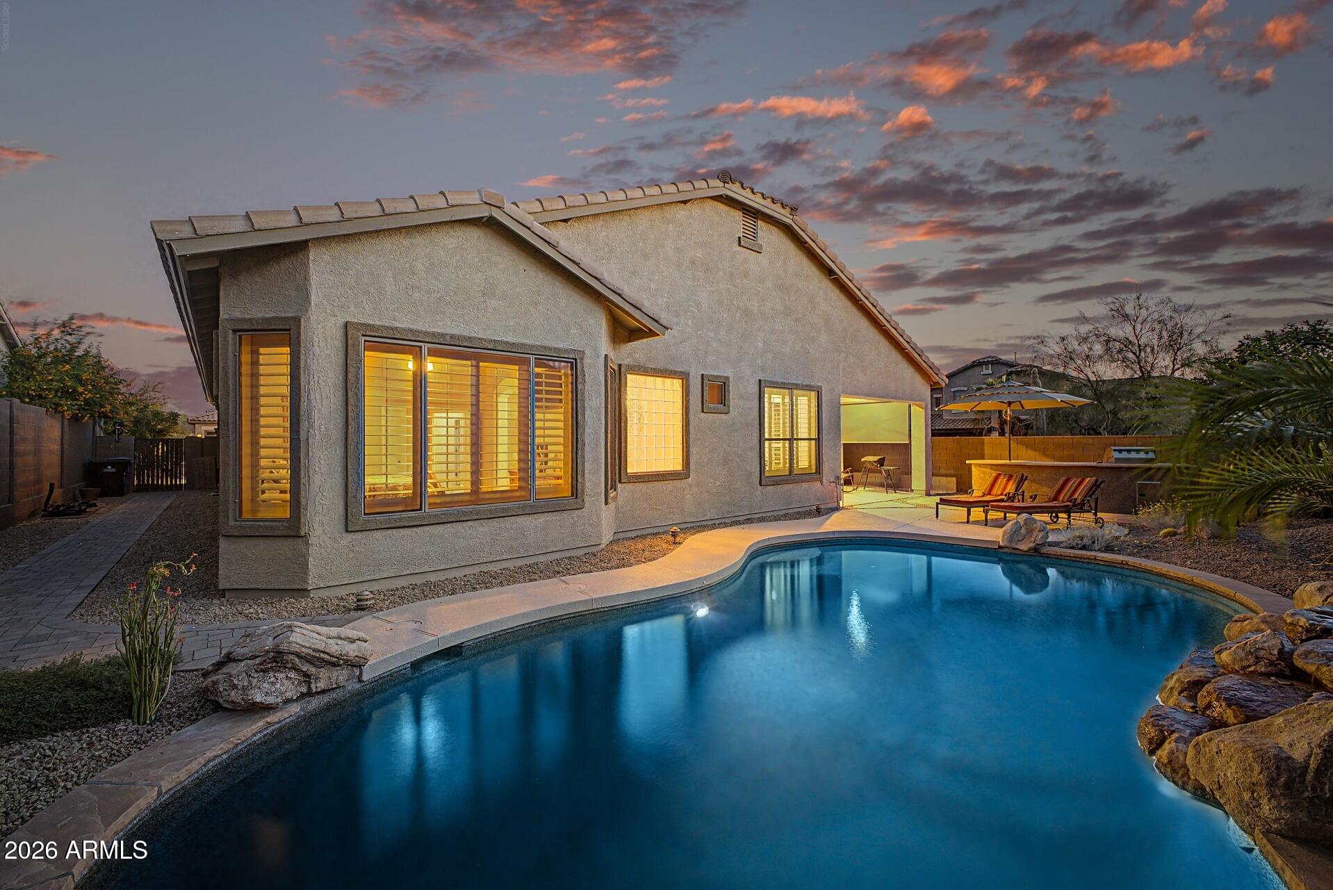 Discover the allure of this charming single-story residence, nestled on a coveted corner lot in the prestigious Tramonto Hillside. The property welcomes you with a gated entry and boasts a sparkling pool that beckons for leisurely afternoons. With a thoughtfully designed floor plan, this home offers ample space for both work and play, featuring dedicated areas perfect for a home office or an elegant formal dining room ideal for entertaining guests.

Large windows adorned with plantation shutters flood each room with natural light, creating an inviting and airy atmosphere. The heart of the home is the expansive kitchen, showcasing a magnificent island, staggered honey maple cabinetry, glass display cabinet inserts, stacked stone backsplash, and a generous walk-in pantry. Culinary enthusiasts will appreciate the three built-in ovens, a gas cooktop stove, and sleek stainless steel appliances, making meal preparation a delight.

Step outside to enjoy the meticulously designed exterior, complete with surround sound, extensive cool decking, flagstone patio extension, a sparkling blue pool, and a brand-new landscaping system that enhances the outdoor aesthetic. The soothing mountain views serve as the perfect backdrop for gatherings, complemented by a substantial built-in barbecue, ideal for alfresco dining and stargazing under the night sky.

The spacious primary bedroom features large windows adorned with shutters and includes an expansive walk-in closet. Additionally, the primary suite boasts a remodeled bathroom with a neutral palette and double sinks, for an everyday spa like experience. Enjoy waking up to your private Arizona sanctuary, complete with pool views and mature landscaping.

A fourth bedroom is thoughtfully split from the others, providing guests with a cozy space during their visits.

This residence is turn-key, exceptionally well maintained, and equipped with a brand-new air conditioning system and a new roof, both featuring a transferable warranty, providing peace of mind and comfort for years to come. Embrace the lifestyle this home offers, where elegance meets functionality in a serene setting.

Experience the perfect blend of relaxed living and comfort in this remarkable Tramonto East residence.  This home is ideally located close to the community park.  Benefit from the low Tramonto HOAs while indulging in outstanding amenities, including picturesque parks, sprawling playgrounds, walking paths, two pools, hot tub, tennis (sometimes pickleball, basketball, sand volleyball, picnic areas and more!
 
This home truly combines luxury, comfort, and convenience, making it the ideal sanctuary for you and your loved ones. Are you ready to make it yours?
