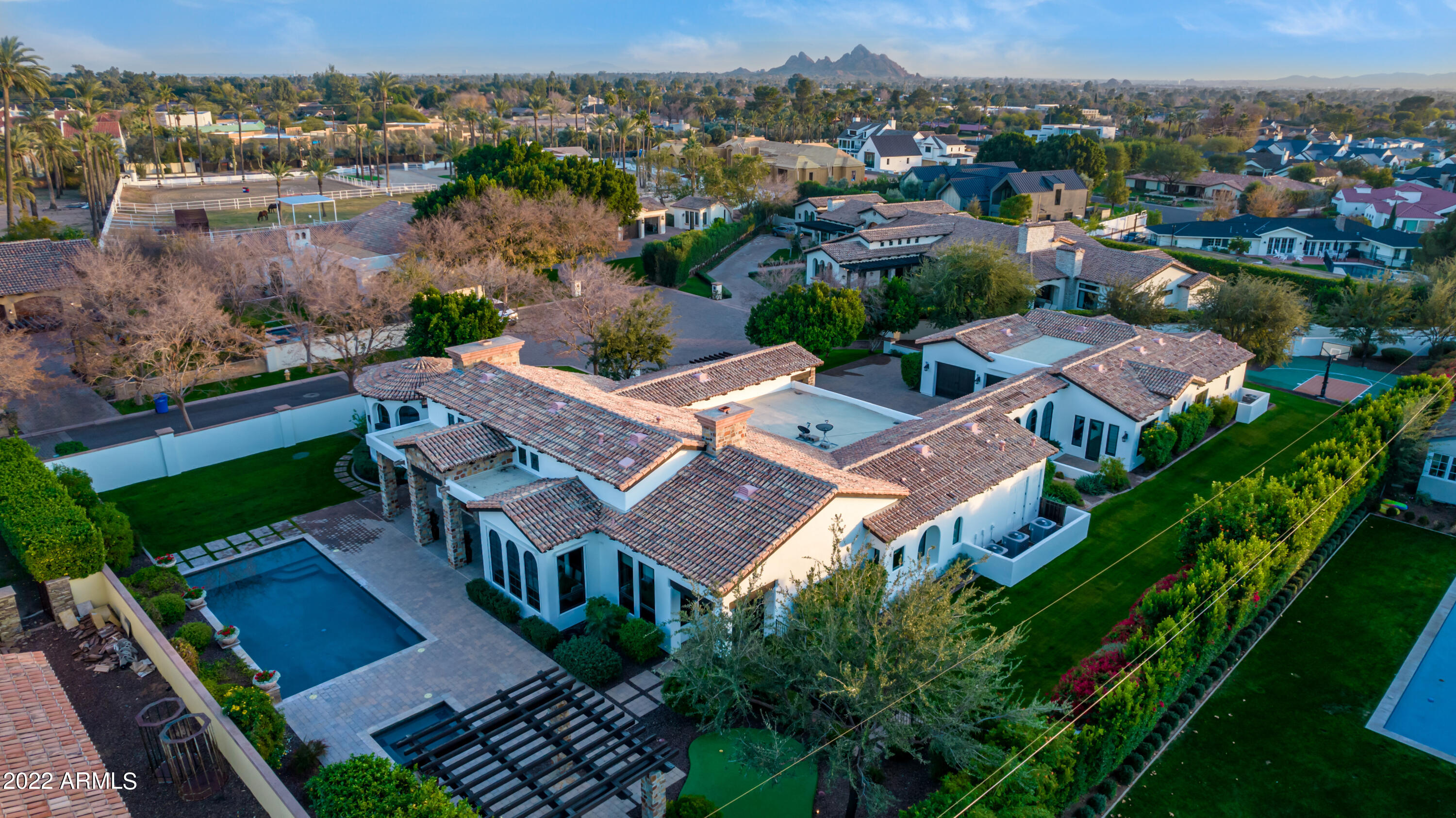 Beautifully updated Old World meets Santa Barbara in this soaring ceiling perfectly turnkey home situated between the Royal Palm Resort & the Phoenician. An ideal hybrid between Paradise Valley and Arcadia living this home is sprawling and expansive with lots of space to entertain in a private gated enclave yet located in the heart of Arcadia with a gated walking path to pop out right onto Exeter. Privacy & protection of 5 homes in a gate, stunning views of Camelback and a large more modern alternative to a ranch home yet beach bike to the main streets of Arcadia proper. Split floorplan with attached casita with its own entrance, kids wing, primary wing and completely separate large office. Entertaining wine bar, 12 new quartzite slabs, open kitchen & low care entertainers backyard.