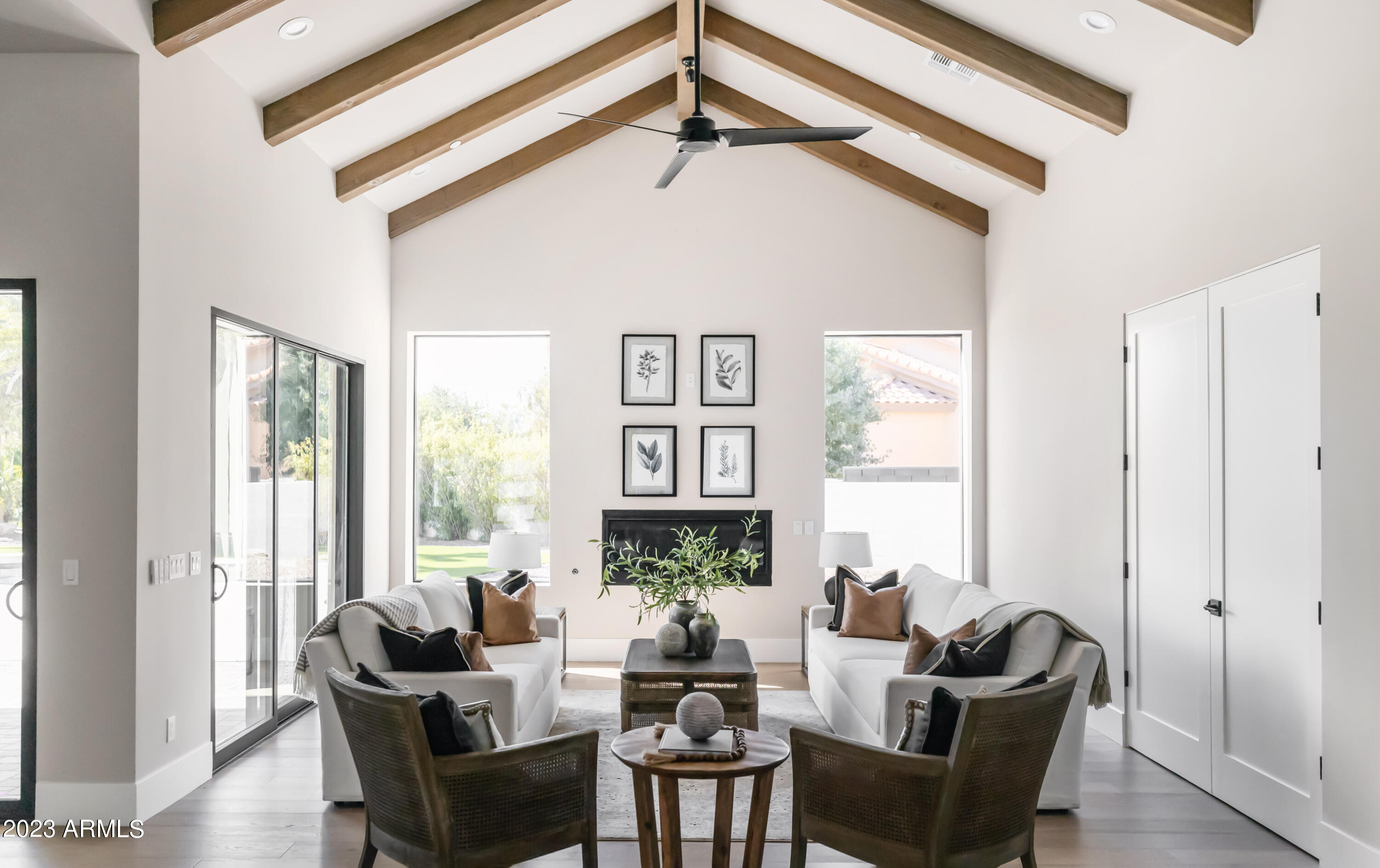Welcome home! Nestled on a quiet street in a 3 C's school neighborhood, this just completed like NEW home was fully rebuilt with all the latest tech & features! All new electrical, plumbing, Trane HVACs, roof, wood flooring, cabinets, tile, quartz countertops, extended 4 car garage, +more. Soaring ceilings with beautiful wood beams are a focal point as soon as you walk through the door. The open floor plan is ideal for entertaining & completed by a teen living room, office/gym, theater/media room, & wine bar. Kitchen features high end Miele, Sub Zero & Wolf appliances. Perfect indoor/outdoor living for the great AZ weather, heated pool with baja shelf and full outdoor kitchen. Enjoy the stunning mountain views from your backyard chipping greens, or from almost any window in your new home. This is like a new home taken down and rebuilt and added on to, not even lived in since completion! Spray foam insulated, new windows, doors, roof, wiring, plumbing, etc! Extended depth garage to fit large SUV/pickups or extra storage + a storage room off side. Full pool bath off back of house for guests while entertaining in resort yard. Docs tab has list of improvement