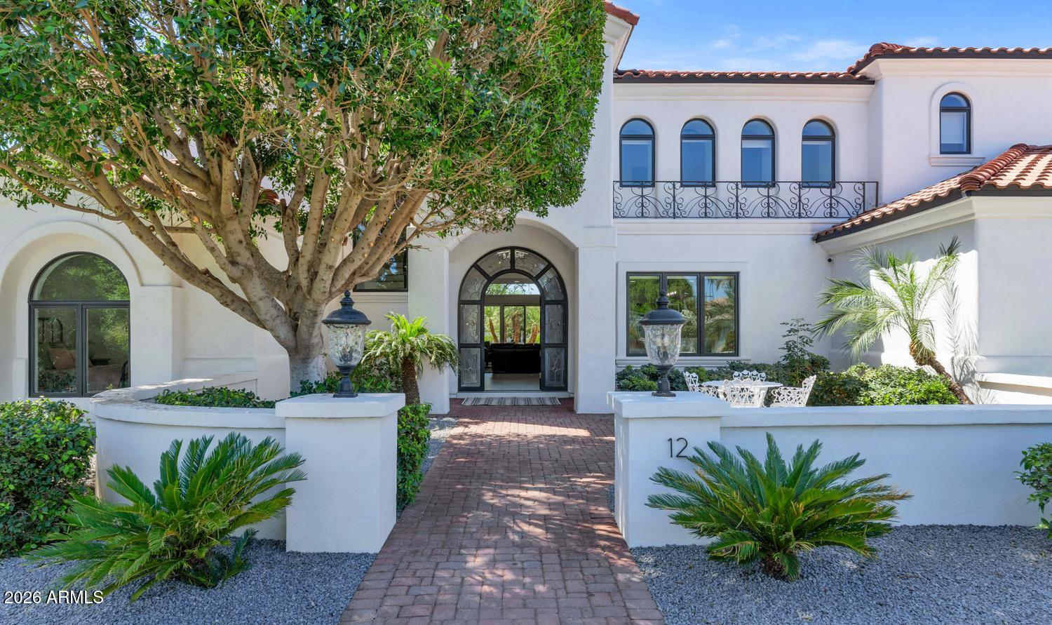 Living Here Feels Like a Permanent Vacation -- With All the Comforts of Home
There's a particular kind of home that doesn't just impress -- it exhales. From the moment you step through the door, this fully reimagined residence inside a private 14-home gated enclave signals that every detail was considered, and nothing was compromised.
Behind private gates shared with just thirteen neighbors, the flood-irrigated grounds do their quiet work keeping your landscape lush while you simply enjoy it -- at a cost most homeowners would find almost comically low.
Inside, the home has been taken down to its bones and rebuilt with the kind of craftsmanship that makes contractors stop and ask questions. Custom cabinetry with hardware that closes with that satisfying, weighted click. Doors that ... swing true. Fixtures chosen not for trend, but for permanence. Lighting that shifts from bright and functional to warm and atmospheric with a tap on your phone -- because the entire home is wired smart and responds to how you actually live.

The kitchen was designed for serious cooking and entertaining -- generous counter runs of backlit Cristallo stone that glow like they're lit from within, wall ovens, a professional range, and an open layout that keeps the cook connected to the room. The bathrooms have each been fully remodeled -- fresh tile, updated fixtures, clean lines -- the kind of finish that makes a hotel bathroom feel ordinary by comparison.
Step outside and you have your own private outdoor zone. A pool. Shade. The kind of afternoon that turns into an evening without you noticing.

This is a move-in ready home in the truest sense -- not "move in and start a project list," but move in and start living. Everything has been done. All that's left is your furniture.