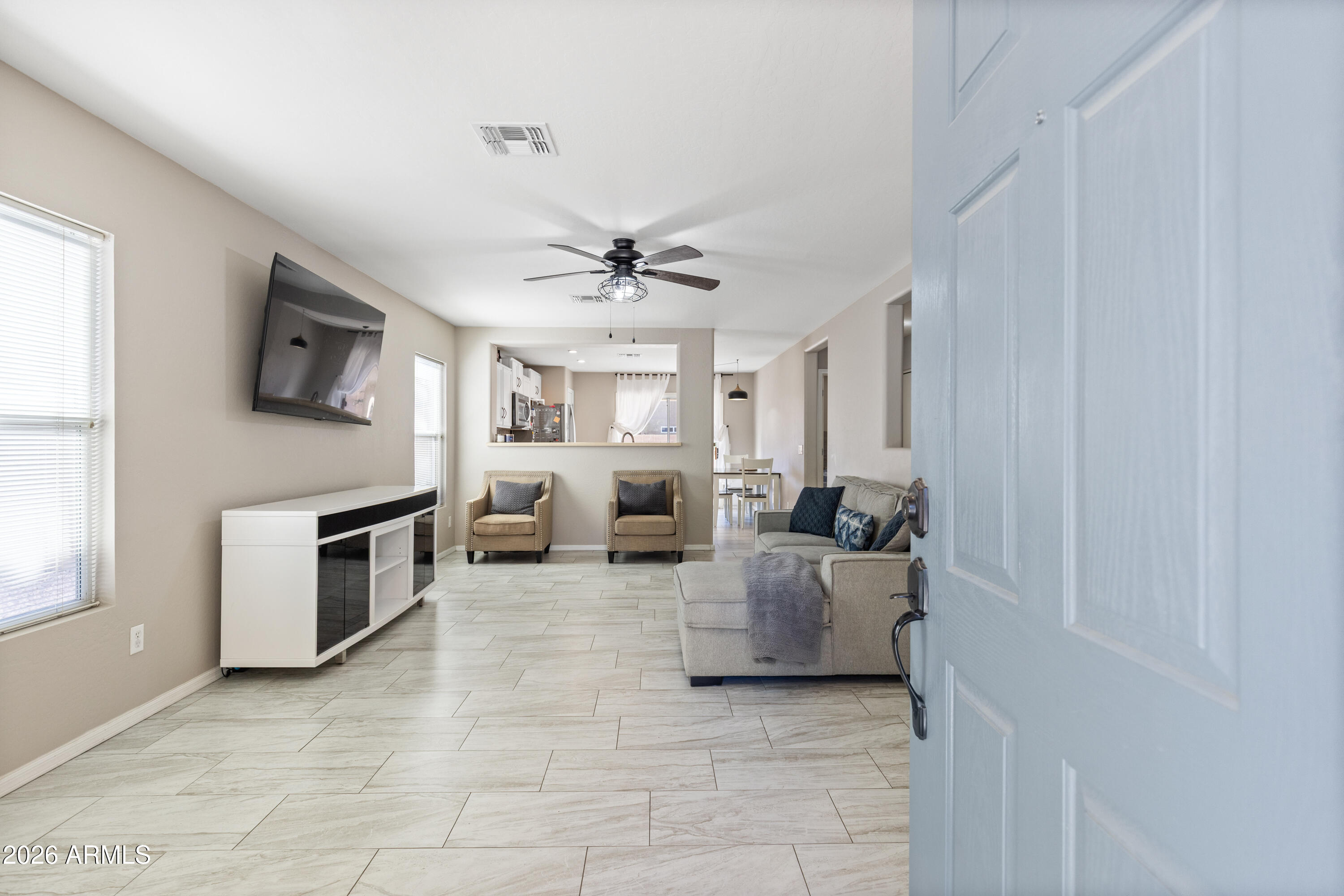 Updated and move-in ready, this Agua Fria Ranch home is a standout in the Northwest Valley. Step inside to an open, airy living space featuring new ceramic tile and abundant natural light. The spacious kitchen offers both a dining area and breakfast bar--perfect for everyday living or entertaining. Generously sized bedrooms continue the clean, cohesive look with consistent flooring throughout. Enjoy a low-maintenance yard and convenient access to parks, shopping, and major routes. Don't miss your chance to make Vogel Ave your next address!