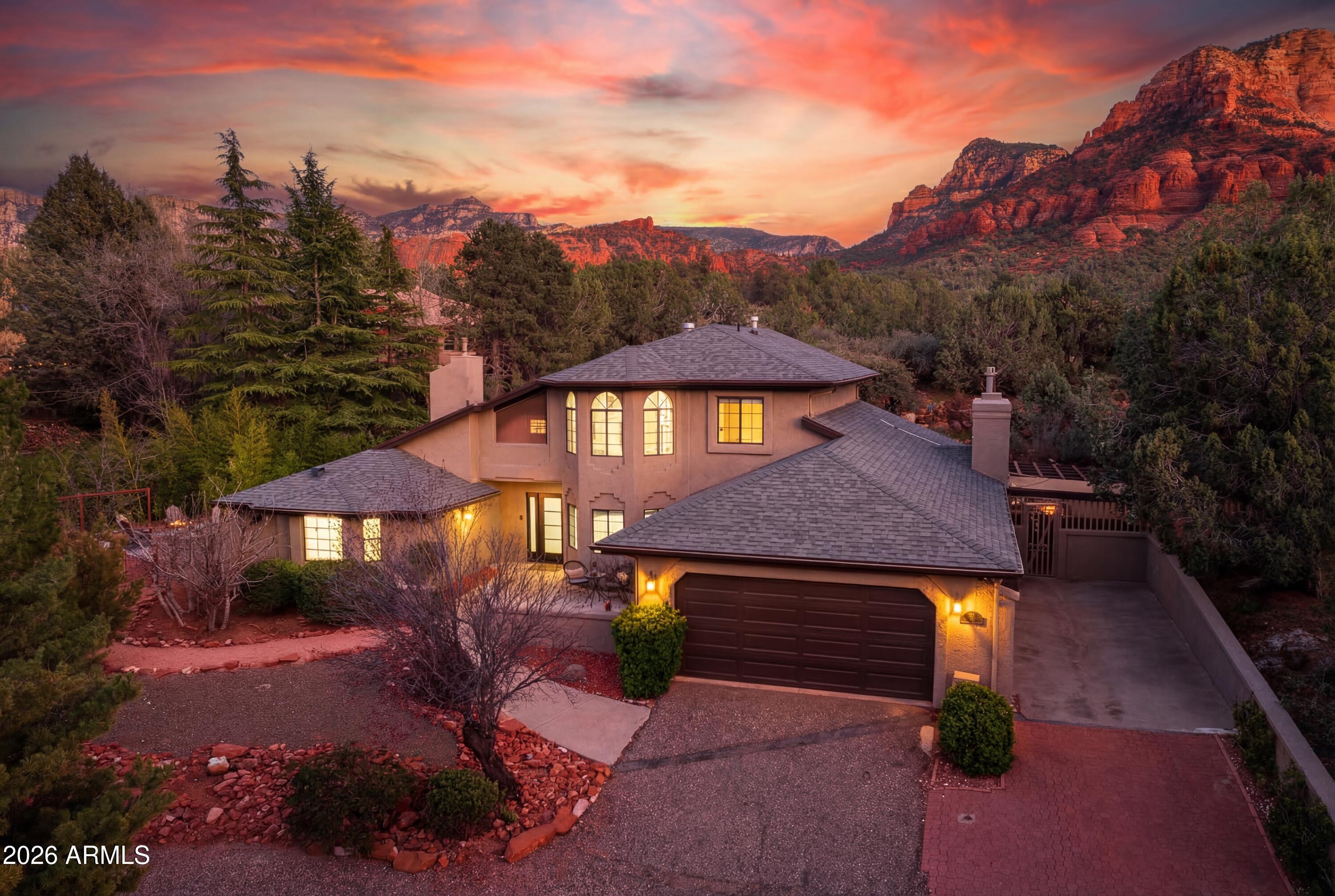 Welcome to the pristine home you've been waiting to come along! A fully renovated, income-producing four-bedroom, three-bath home in Sedona's Chapel area that's turnkey & fully furnished, w/a variety of red rock views to enjoy.

Operating as a sleek short-term rental, this property is designed for immediate use, with everything included. It's a true plug-and-play opportunity for buyers looking to enter the Sedona market without the time, cost, or uncertainty of setup.

The location strikes a balance between convenience and seclusion. Tucked at the end of a private cul-de-sac on a flagpole lot, the home feels quiet and removed--yet sits just 2 blocks from the new Outbound Sedona hotel. Guests can walk to the bar, dining, and spa amenities and then come back to quiet privacy.

MORE DET -------------------------

98 DOODLEBUG ROAD HIGHLIGHTS & DETAILS:

Surrounding the property is a lush riparian setting, supported by a nearby drainage corridor that naturally attracts wildlife. The area is rich with birdlife--including great blue herons--and is just blocks from Oak Creek, contributing to a landscape of mature greenery, tall pines, and year-round foliage.

Rather than expansive panoramic views, the home offers something more intimate--peekaboo red rock vistas, including Elephant Rock and Airport Mesa, framed by trees and natural landscape. The setting feels sheltered, peaceful, and distinctly removed from the busier parts of town.

Inside, the home has been completely reimagined with a clean, modern aesthetic and a calming palette of soft whites, creams, and pale beiges. Upgrades include new a new roof, exterior paint, whole-home flooring, whole-home fresh interior paint, whole-home lighting, all new doors, and beautifully renovated kitchen and bathrooms.

The layout is designed to host comfortably, with four bedrooms, three full baths, + two separate living room areas, and an upper level loft-style office space. With a spacious 2959 sq.ft of useable living space that allowing for both gathering and privacy. 

The primary suite is pure zen and comfort with a fireplace, a slider to walk-out to outdoor seating plus it features a soaking tub with views, a custom walk-in shower, and dual vanity, creating a true retreat within the home.

Additional features include a dedicated dining space, a separate formal living room, a more relaxed living room with a fireplace that integrates in a great room with the kitchen, plus a separate game room/workshop outbuilding 

Outdoor living is a key part of the experience of this home.

The property offers multiple seating areas, covered pergolas for dining and lounging, a putting green, a game area, and a fire pit positioned to capture views of Elephant Rock. Mature landscaping, irrigation, and low-maintenance grounds make for easy upkeep.

The property is well-equipped for larger groups, with a two-car garage featuring fresh paint and epoxy flooring, RV parking, and other off-street parking areas.

For buyers seeking a fully operational, design-forward short-term rental in a proven location, this home offers immediate usability, strong guest appeal, and a compelling value relative to the cost of recreating it.

See the listing documents for a complete list of the 2025 home renovations. 

Since this is an active AirBnb, all appointments must be approved in advance. Since the driveway is private access, there are no drive-bys allowed so as to not disturb guests.