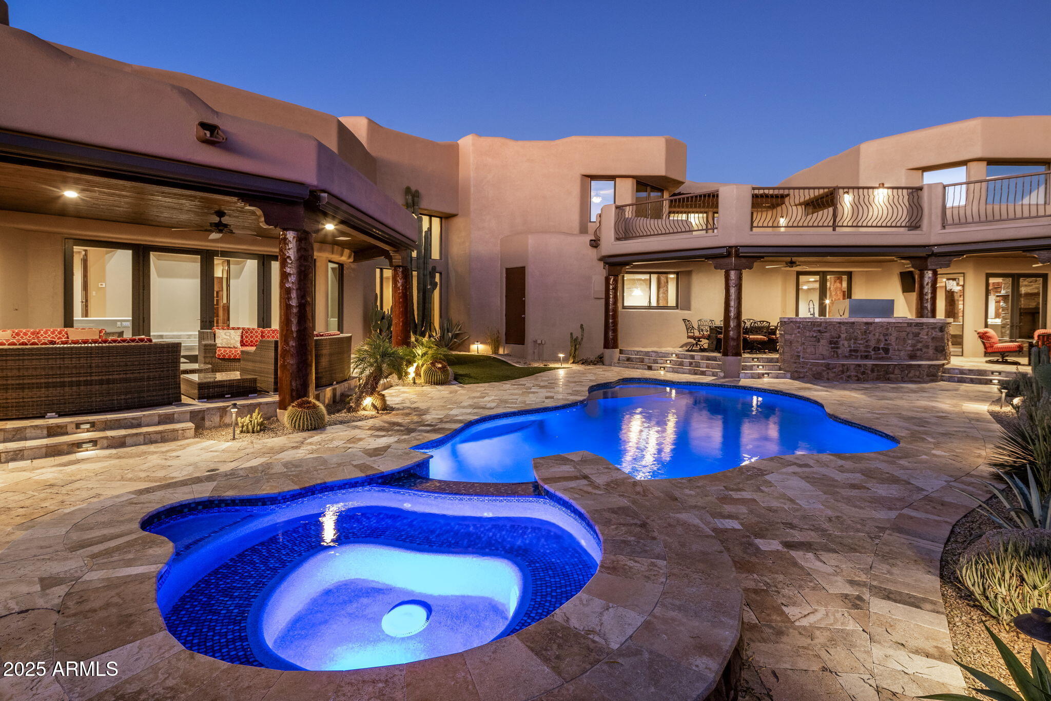 $1M below recent appraisal, completed in February of this year, priced at well under $400/sq. ft., the lowest price/sq. ft. in all of Desert Mountain. RARE Lifestyle / Social Membership Available. Impeccably maintained and renovated in late 2016, including key components like all new HVAC units with warranties still in place, all new pool equipment in 2016, completely recoated roof within past 6 months, whole home water filtration system, etc. The home showcases top-tier finishes and upgrades throughout. The showpiece chef's kitchen features a 60''Thermador gas range with oven and warming drawer, additional Thermador double ovens and microwave, an oversized glass-door Sub-Zero refrigerator & freezer, two Sub-Zero ice makers (including one in the bar), Miele dishwasher, built-in Wolf coffee system, and built-in Napa wine system. A large walk-in pantry, custom alder cabinetry, granite countertops and backsplash, and an oversized granite island complete this entertainer's dream space. Expansive French doors along the back of the home open to two large resort-style patios, creating seamless indoor/outdoor living. A full outdoor kitchen includes a large Viking grill and stove, plus a Senora beverage refrigerator, ideal for al fresco dining and entertaining. Professionally landscaped grounds include all-new landscape lighting and irrigation, a refinished Pebble Sheen pool with spillover spa and glass tile, new pool equipment with IntelliTouch controls, and multiple seating and lounging areas. Outdoor living is enhanced by a dramatic see-through fireplace, electric patio blinds, and a misting system that can drop the temperature by approximately 20 degrees in minutes, perfect for year-round enjoyment. The main residence offers 5 bedrooms (including two primary suites, one on the main level and a junior primary upstairs), 5 full bathrooms and 2 half baths. One oversized bedroom is currently used as a gym, and the gym equipment conveys. Additional interior highlights include fully electric blackout shades in all 5 bedrooms and along the rear living spaces; a Control4 home automation system with touch-screen and smartphone/tablet control; an elevator to the second floor; a main-floor office with full-wall built-in shelving; a luxurious primary bath with large steam shower, Bluetooth stereo, LED lighting, and car-wash-style shower heads and mister; a large accessory closet off the primary bath; and a full home security system with cameras. The property also offers an oversized 5-car garage, with the fifth bay ideal for a workshop or additional storage. Tech-forward conveniences include myQ garage door control and the ability to view all five parking spots via your smartphone. Exterior renovations include a completely redesigned front entry and rear patios, with pool decking finished in travertine. The home has been freshly painted inside and out, and the roof was resurfaced in 2025. Major systems have been significantly updated with three new water heaters and five newer HVAC systems, making this a move-in-ready, low-maintenance luxury residence. A separate 1,100 sq ft stand-alone casita provides ideal guest or multigenerational living, offering a large bedroom, two full bathrooms, full kitchen, dining area, living room, its own patio, and a rooftop observation/seating deck. The casita's yard features lush fruit trees, including plum, peach, lemon, and orange. This exceptional estate is priced below market value for Desert Mountain, with motivated sellers and an optional, highly sought-after Desert Mountain lifestyle club membership available. Nestled in prestigious Apache Peak Village within the highly sought-after, guard-gated golf community of Desert Mountain, this 9,004sf estate offers true resort-style living at approximately 3,300 feet elevation--typically enjoying temperatures about 10 degrees cooler than the Phoenix valley below.