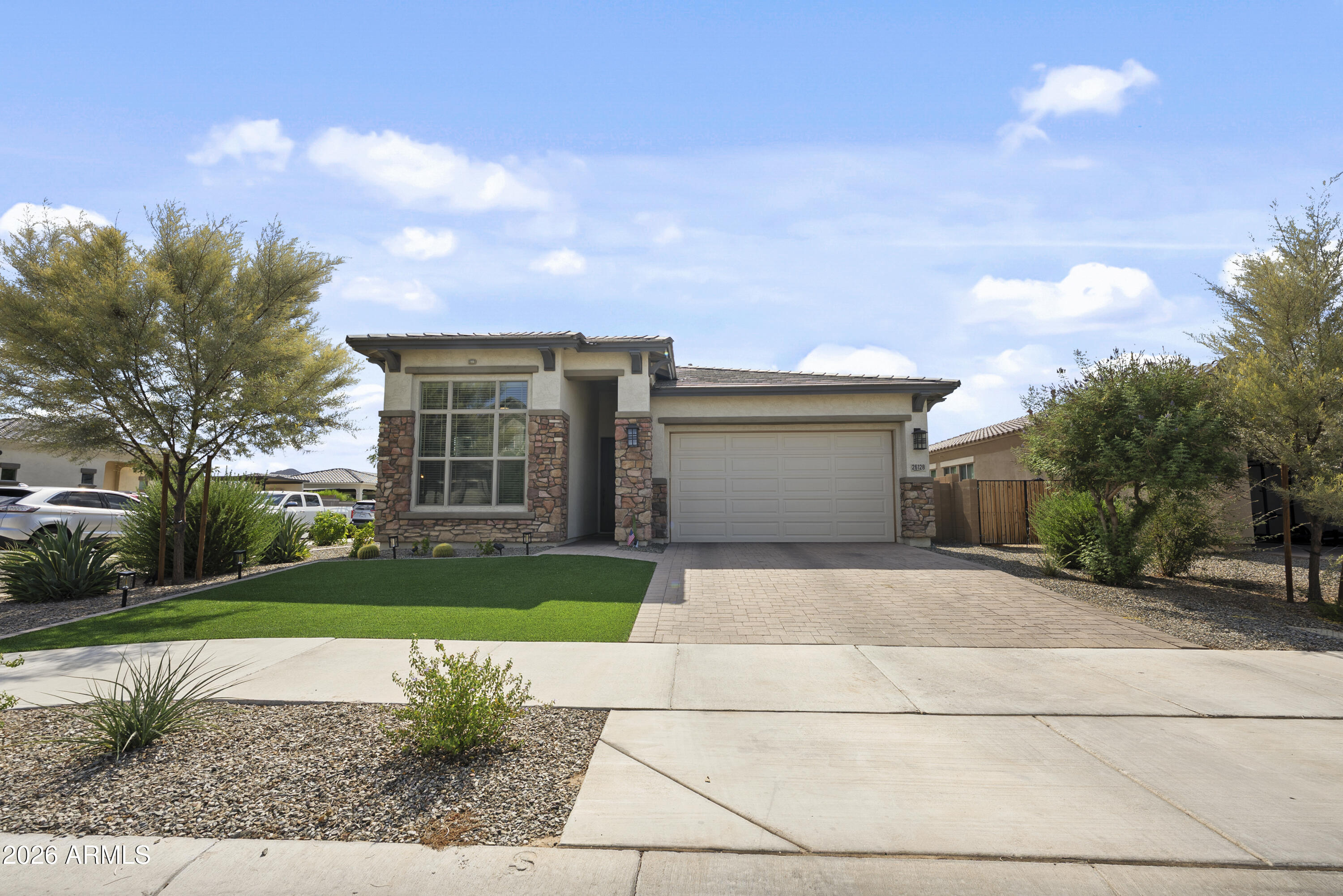 Welcome to Harvest, one of Queen Creek's most in demand communities. This is the popular Holbert plan by David Weekley, a single level home with 4 bedrooms, 3 full baths, and upgrades everywhere you look. The kitchen features the gourmet GE stainless appliance package with gas cooktop, wall oven, pot filler, and a full granite backsplash. White shaker cabinets run throughout, including a built-in dining room hutch and extra cabinets above the washer and dryer. Upgraded tile flows through the main living areas and bedrooms. Soaring 12 foot ceilings in the living room and front bedroom make the whole home feel open and bright. The owner's suite has a super shower with tile to the ceiling, semi-frameless glass, and matte black finishes. You'll also love the 8 foot doors, 2 inch wood blinds, soft water loop, upgraded Modern baseboards, surround sound pre-wire. All of this sits on a corner lot with an extended covered patio. Washer, dryer, and fridge are included. BONUS - Taexx system pest control. Easy pest control delivery built into the home - Harvest offers two community pools, a lap pool and a play pool, plus a fishing lake, splash pad, parks, and year round HOA events. Come see why so many buyers want to call Harvest home.