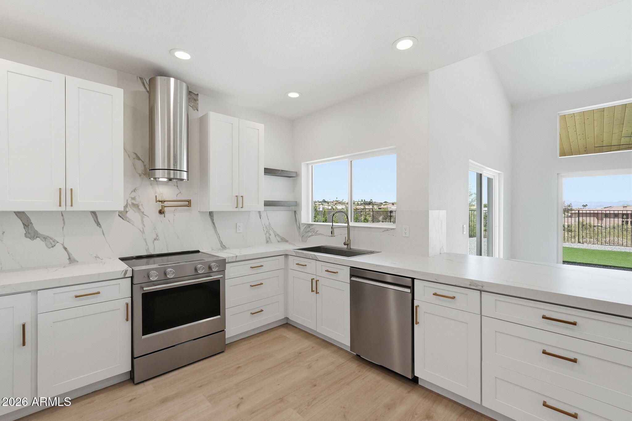 Views!! Views!! This stunning single level home is nestled on an un obstructed view top lot. You enter the amazing massive rock formation canyon known as Sunburst Dr to get to the home, so every drive home is an experience.  Every surface inside and out of this reimagined home has been professionally designed. It literally looks, smells and feels like a brand new home, with the added bonus of a premium view top lot no longer found for new construction. There is even a completed pool design ready to build if so desired. The soaring ceilings give it a feel of a home twice its size. The new gourmet kitchen looks like a magazine cover with its porcelain slab countertops and European finishes. RV parking. Massive garage ceilings have ample room for two car lifts and then some. Other home highlights include luxury vinyl plank throughout. Dual pane windows, resort style bathrooms, wood ceilings, new doors and hardware, all new light fixtures inside and out, paint, trim, custom fireplace features, garage door and opener, epoxy coat, outdoor kitchen, outdoor fire pit area, paver sitting area front and back, updated roof, full landscape upgrade , including synthetic grass. You will not want to miss out on this amazing desert gem.