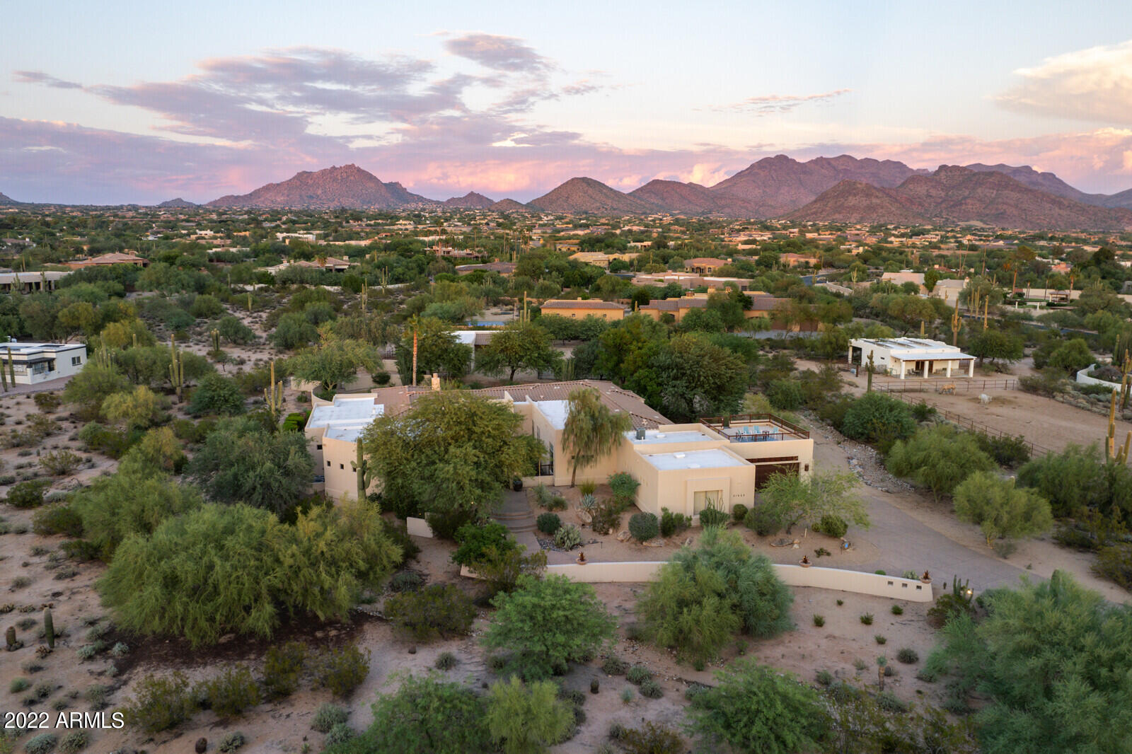 $300k Price change! Impressive estate in GATED Los Gatos in premier North Scottsdale!  Enjoy the privacy of 2.4 acres all while being minutes to everything convenient: shopping, golf, dining & highway access. Serenity behind your one-of-a-kind entry gate where sounds of waterfalls cascading into your private pond lead you to luxurious entry doors. Grand views at entry over formal living w/stunning stacked stone fireplace & outdoor SPARKLING POOL! Spacious total of 5 bedrooms, 2 OFFICES + Hobby/Exercise room + Bonus Sitting View Room, 5 full baths & 2 half baths! (CASITA has full kitchen, living & bedroom & 2 baths!) Wine aficionados dream w/750 BOTTLE WINE ROOM Rare for area to have horse set up! 4 stall mare motel w/barnmaster fittings&auto water system. 4 CAR GARAGE w/room for much more! Walk out to enclosed patio off entertainment room where mountain views and sunrises great your morning retreat and venture up the spiral staircase to the rooftop deck to take in more of the sunrise and sunset views over the McDowell's and enjoy evening city lights and sunsets with view to Camelback! 
Not a horse owner...HOA has previously approved conversion of barn so decide what works for you.  Don't need the arena...how about a pickle ball court or sport court? you design this is a unique opportunity to own so much land behind the gates & within great proximity to so much lifestyle!