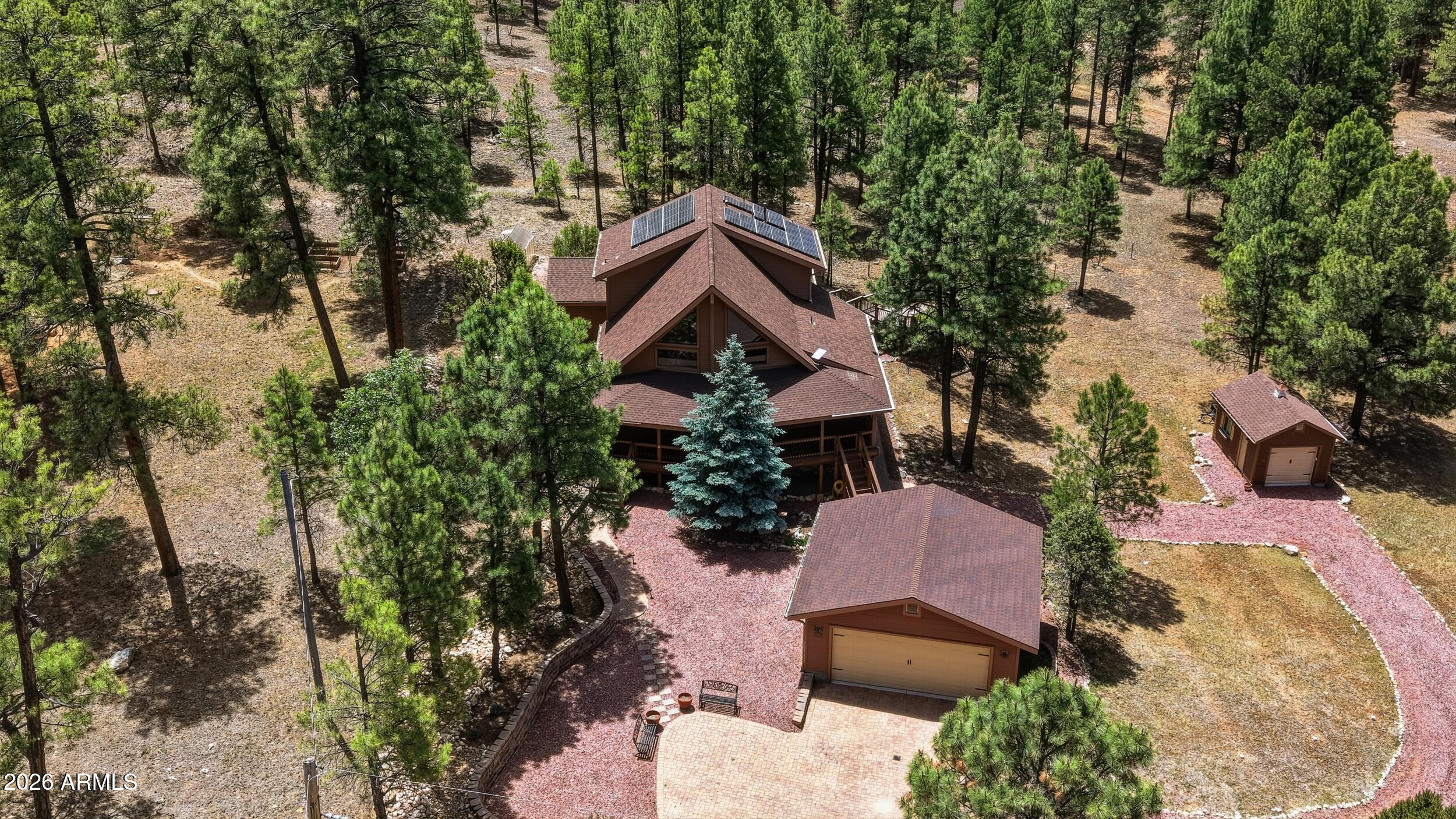 This beautiful unique custom built cabin is everything you dreamed.  Lot has privacy with two sides backing greenbelt, great mature trees, nice paver driveway and so much more. Enter onto the maintenance free partial wrap deck which steps down to a great entertaining area. Two car garage as well as another garage perfect for your UTV and toys. Inside you are welcomed by the T&G ceilings with recessed lighting and the wall of windows that looks out to a beautiful front yard. Downstairs has an oversized master bedroom bath suite with a large walkin closet, guest bedroom and bathroom, and main living area. Upstairs has a bedroom bathroom suite for privacy for your guest.  Newer appliances, AC, heater. Home also has a generator and solar. (Solar is leased)  This home is a beautiful FT home