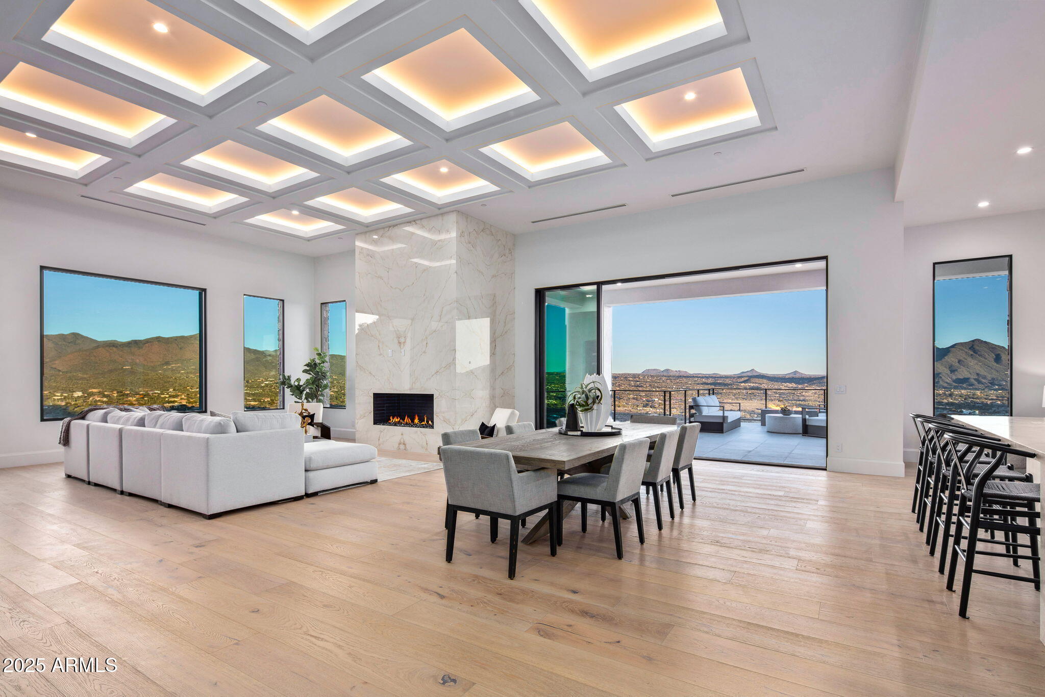 AUCTION BIDDING OPEN: Current High Bid $3M. Absolutely selling on May 14th. Previously Listed $5.995M.  No Reserve.  Saturday and Sunday 1-4 p.m.

**Perched high in the Cave Creek hills within the gated enclave of Seven Sisters Estate, this desert contemporary masterpiece commands sweeping 270-degree panoramas of the Sonoran Desert, the Valley, and glittering city lights at dusk. The 8,682-square-foot residence unfolds across one thoughtfully composed level of primary living, where walls of glass dissolve the boundary between interior refinement and raw desert grandeur. Open great room plan with five luxury ensuite bedrooms,  a sports bar, wine room and a 7-car garage with lift capability. The primary suite is a private retreat featuring a spa-inspired bath, a gym with steam room, and captivating views. Additional spaces include a dedicated office, an entertainer's bar, a hidden catering kitchen, and a guest wing with three en suite bedrooms.

The lower level offers even more for the ultimate lifestyle, with a sports-style bar, a wine room, billiards area, and a game room. The fifth bedroom is versatile and can transform into a home theater. The 7-car garage, equipped to accommodate lifts, and a sleek elevator add to the home's thoughtful design.

A serene interior courtyard is perfect for pets, morning meditation, or intimate evenings by the fire.

The exterior's striking stone and stucco blend harmoniously with the home's streamlined modern lines, while walls of glass bring the desert's beauty indoors. The interior palette, curated by renowned Renee Christina Interior Design, features neutral tones, oak flooring, exquisite stone accents, designer lighting, luxury WOLF/SUBZERO appliances, and bespoke cabinetry.

This exclusive property is the first of five custom homes by Diamond West in the coveted Seven Sisters Estates. Each home is situated on a 4+ acre site amidst pristine desert flora, stunning rock outcroppings, and iconic landmarks such as Elephant Butte, the Seven Sisters, and views extending to Camelback Mountain and the McDowell range.