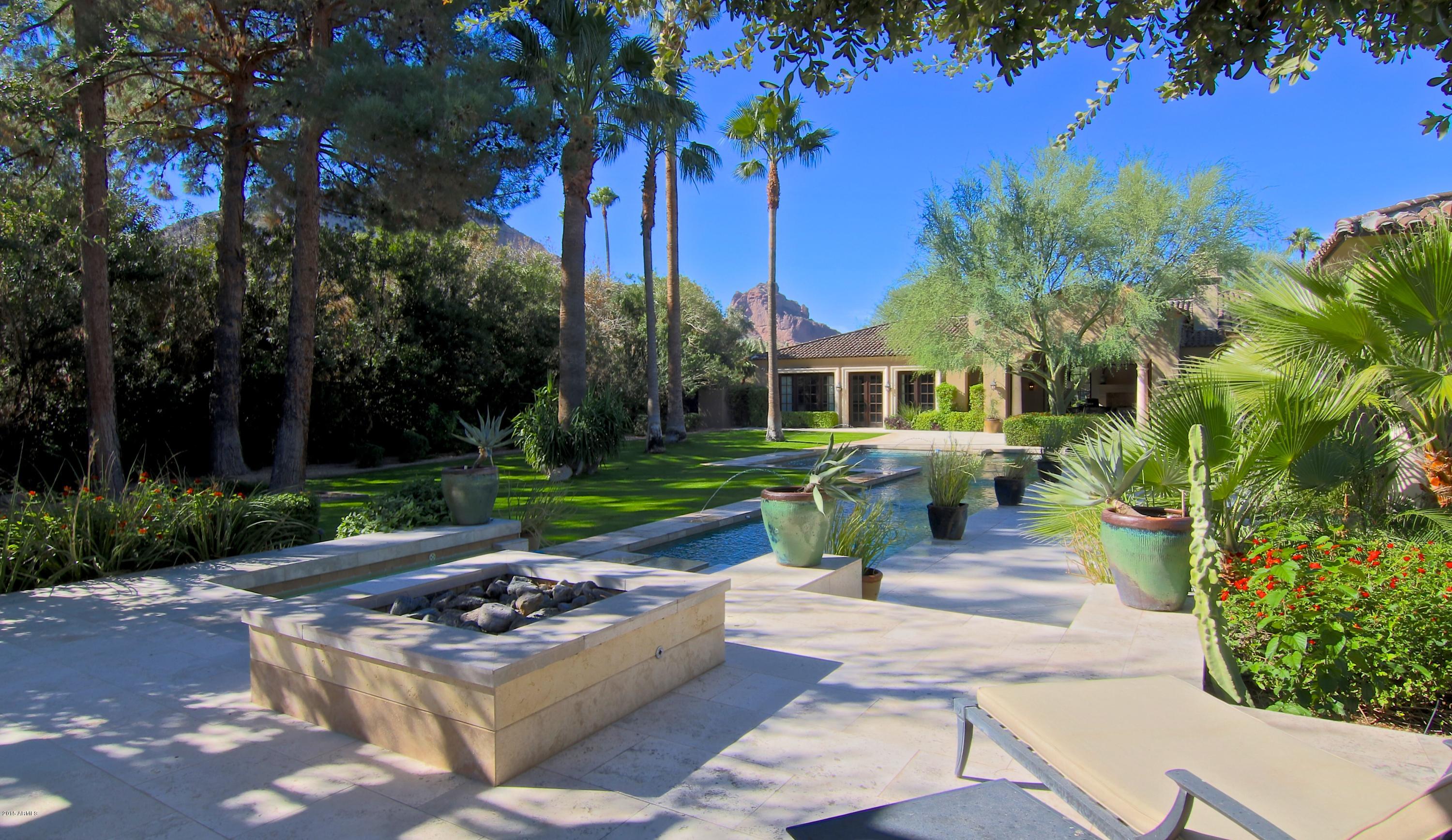 Remarkable and beyond compare Luxury Estate that exudes quality and attention to detail in every aspect by Carson Poetzl Archictects. Located in the prestigious guard-gated subdivision of Finisterre, which may be considered as the ''Bel Air'' of Paradise Valley. A superb interior lot including striking views of Camelback Mountain. The master wing is heavenly with one of the most eye-catching baths, impressive office and grand closet. Step outside to enjoy the breathtaking backyard  with a opulent pool, spa and outdoor kitchen in a resort style setting. All bedrooms are ample & ensuite.The guest house provides a wonderful retreat for company. From the Onyx bar, wine cellar, sublime kitchen to every corner of this property, did not miss a step!   This home is impeccable from Top to Bottom!