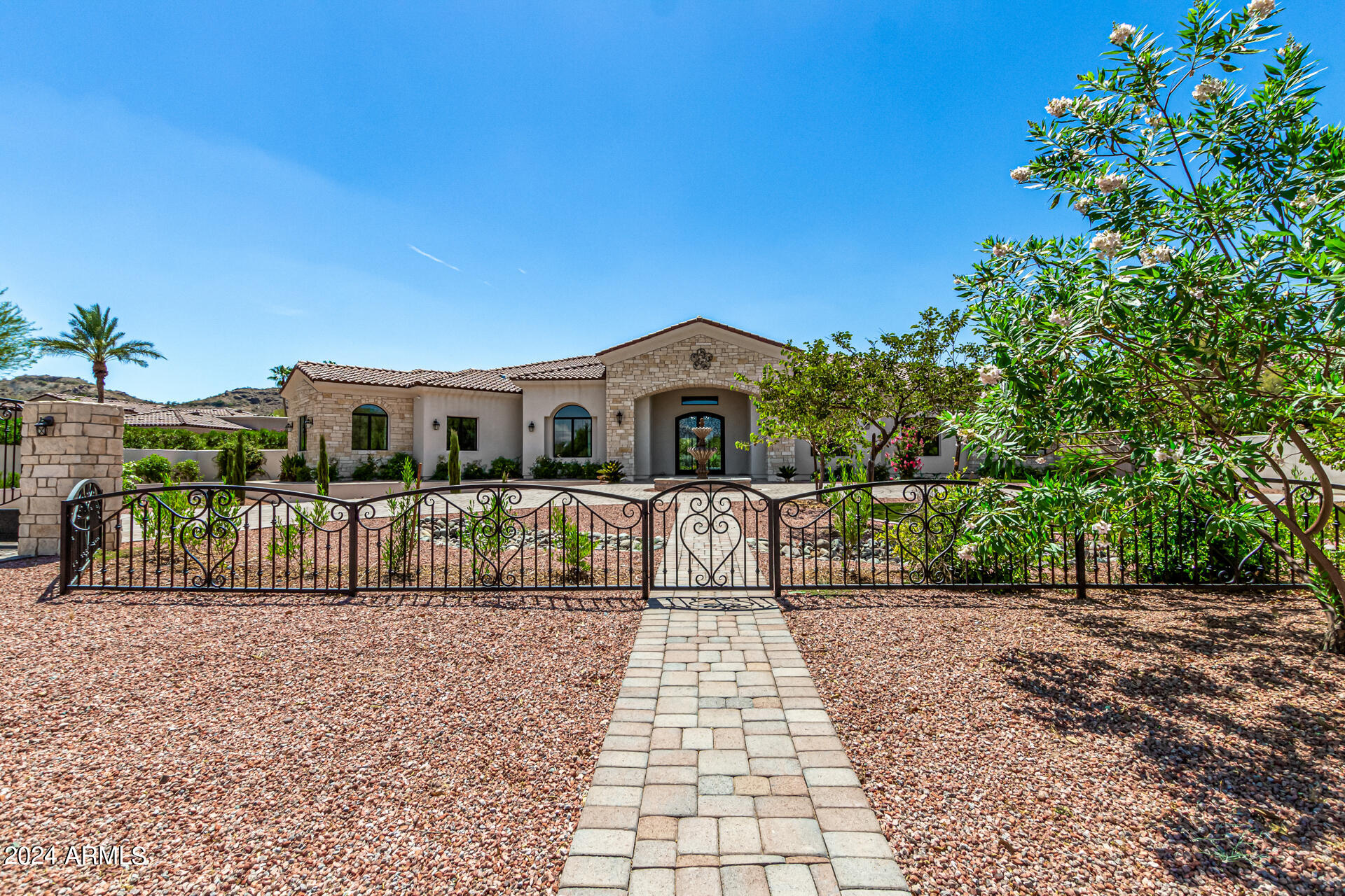 Priced to sell! Mediterranean style home in a highly coveted part of Paradise Valley. Mother in law suite includes its own washer dryer and kitchen along with its own exit to the patio and garage. You're going to love spending time in this oversized master bedroom with spacious sitting area and coffee counter with refrigerator built in making for more convenient mornings. Master bathroom includes makeup area as well as free standing tub with beautiful views into your private backyard. Gorgeous resort style backyard includes gas fireplace that has never been used. Private office with wall to wall built in cabinets and shelves. Sound system has been installed in master, formal living area as well as formal dining area and family room! Pool and spa with roof deck makes sunset/mountain views in your backyard hard to resist. Home includes pantry/prep kitchen and movie theatre as well. House includes an additional room that can be used for flex, gym or yoga depending on your preference. Faux wood beams in the family room as well as dining area. Tesla Solar plus Tesla pack make for an energy efficient and easy to charge home.  Too many additional features to list.