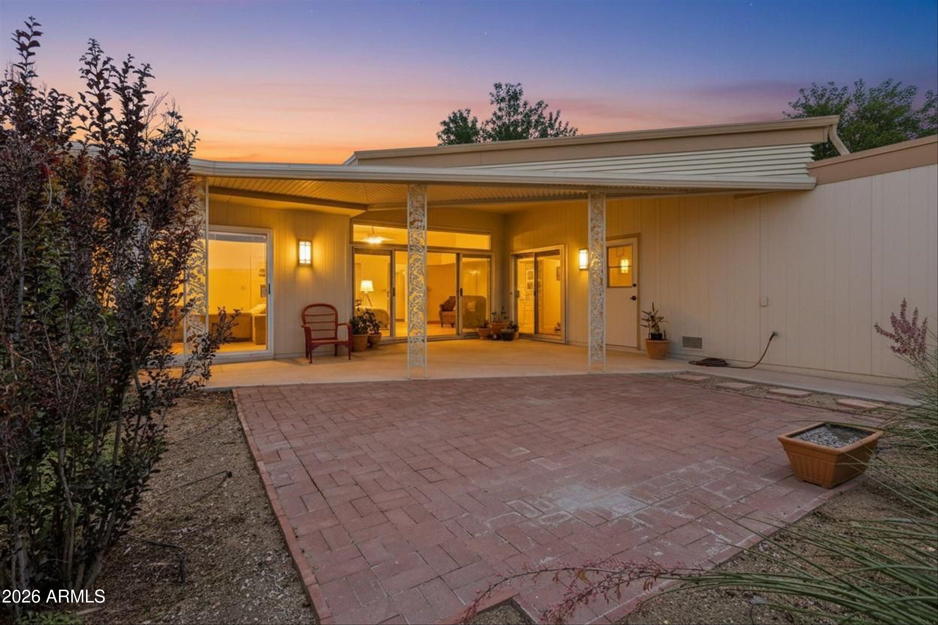 RARELY AVAILABLE large patio home with private courtyard entry and soaring 10' ceilings! Low maintenance perfect for a primary or secondary residence! Bright, open floorplan with abundant natural light, shutters and seamless indoor-outdoor living. Expansive 8'x12' 3-panel slider opens to a covered patio--perfect for entertaining or relaxing Arizona evenings. Energy-efficient dual-pane windows and added patio door insulation help keep utilities low. Spacious kitchen offers abundant cabinetry, generous counter space, and inside laundry. LVP flooring throughout--NO carpet! HVAC 2021, and a rare 2-car garage with workbench and electrical. Walk to the Lakeview Community Center and enjoy all the amenities located within Sun City! Move-in ready and a must-see!