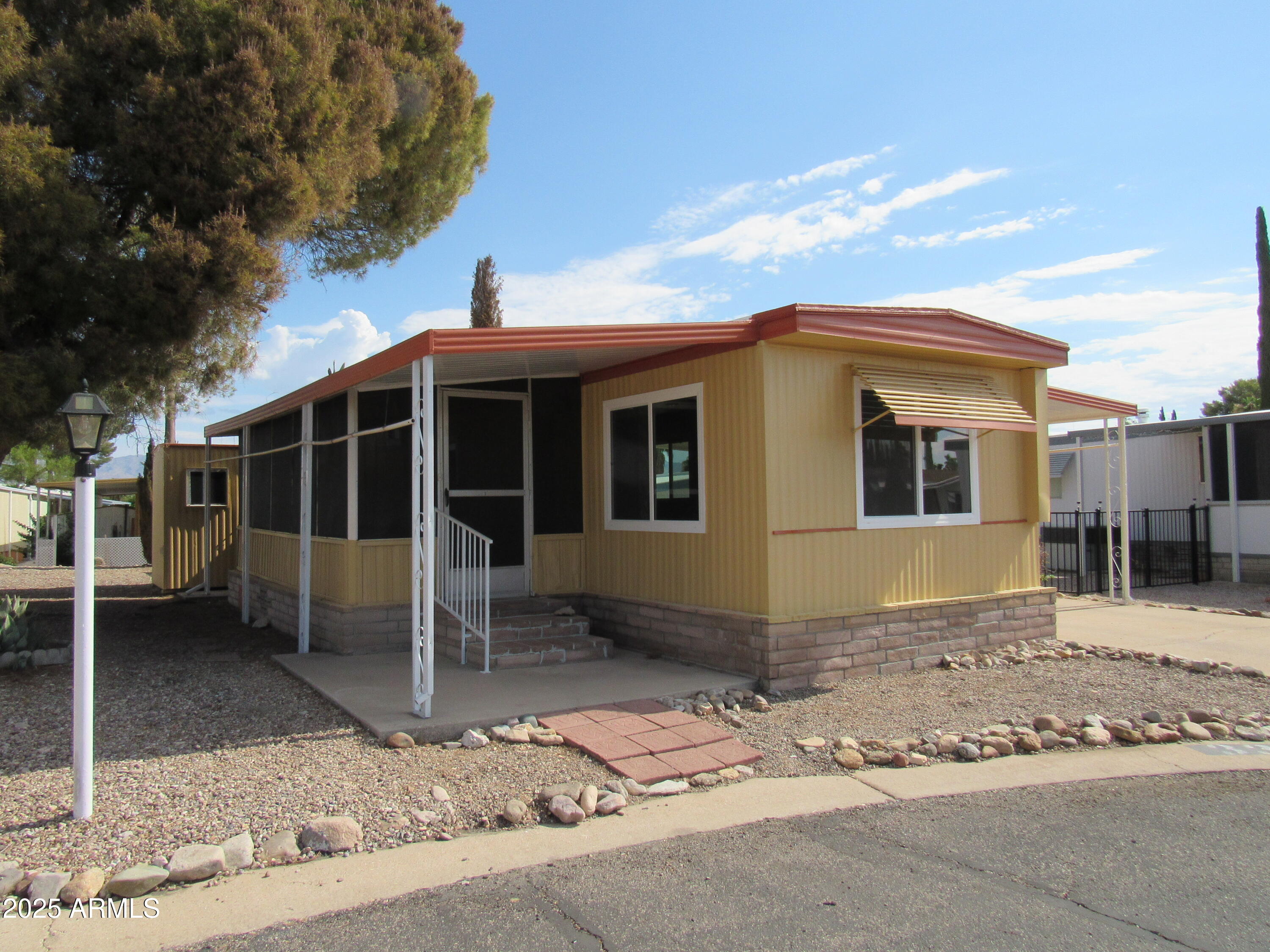 This home is located on a quiet street. It has been updated throughout with newer cabinets in the kitchen. Recessed lighting in the kitchen and living room.
It comes with all appliances except for washer and dryer. There is an area on the screened porch for the hook up for the washer and dryer. Matching exterior storage shed.
Double pane windows. Awnings on both sides and front window and bedroom window.
Two ceiling fans. One in the living room and one in the bedroom.
Nice bathroom vanity with storage and matching mirror.  Walk in shower.
All laminate flooring thorough out the home.
All matching interior 6 panel doors.
55+
