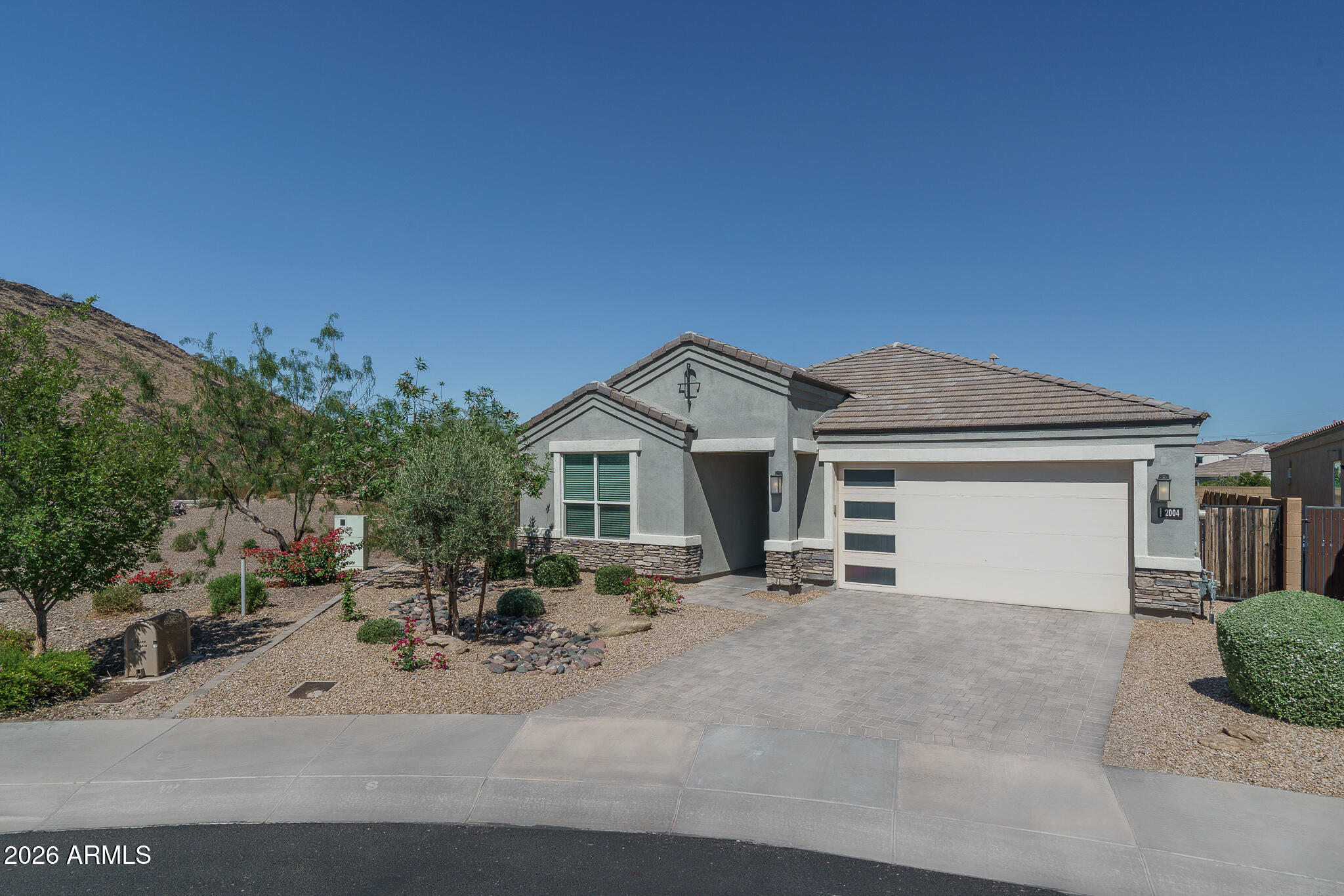 Nestled within the gated Stone Butte community and surrounded by breathtaking mountain views, this 2020 D.R. Horton Jordan Model was designed for both luxurious everyday living and effortless entertaining. The backyard features a sparkling modern heated pool, elevated spa, and stunning 360-degree mountain views. Inside, dramatic 90-degree stacking glass doors seamlessly connect the central courtyard to the dining and living areas, creating the ultimate indoor-outdoor lifestyle. The light-filled open floor plan offers a true split-bedroom layout and a beautifully designed kitchen complete with a gas range, stainless steel appliances, pantry, and designer lighting throughout. The oversized primary suite features a soaking tub, glass walk-in shower, dual vanities, and abundant storage. The expansive primary closet offers exceptional space and conveniently connects directly to the generously sized laundry room. Additional upgrades include a water softener already installed in the garage. Set on arguably the best lot in the community, this home enjoys unmatched privacy and unobstructed views with no homes directly behind or to the left. Across the street, a large park with lush grass and mature trees adds even more open space and beauty to the setting. Residents of Stone Butte enjoy walking paths, parks, playgrounds, and multiple green spaces--all while being just 10 minutes from Desert Ridge Marketplace, with easy access to Loop 101 and SR-51, and only 20 minutes from Phoenix Sky Harbor International Airport.