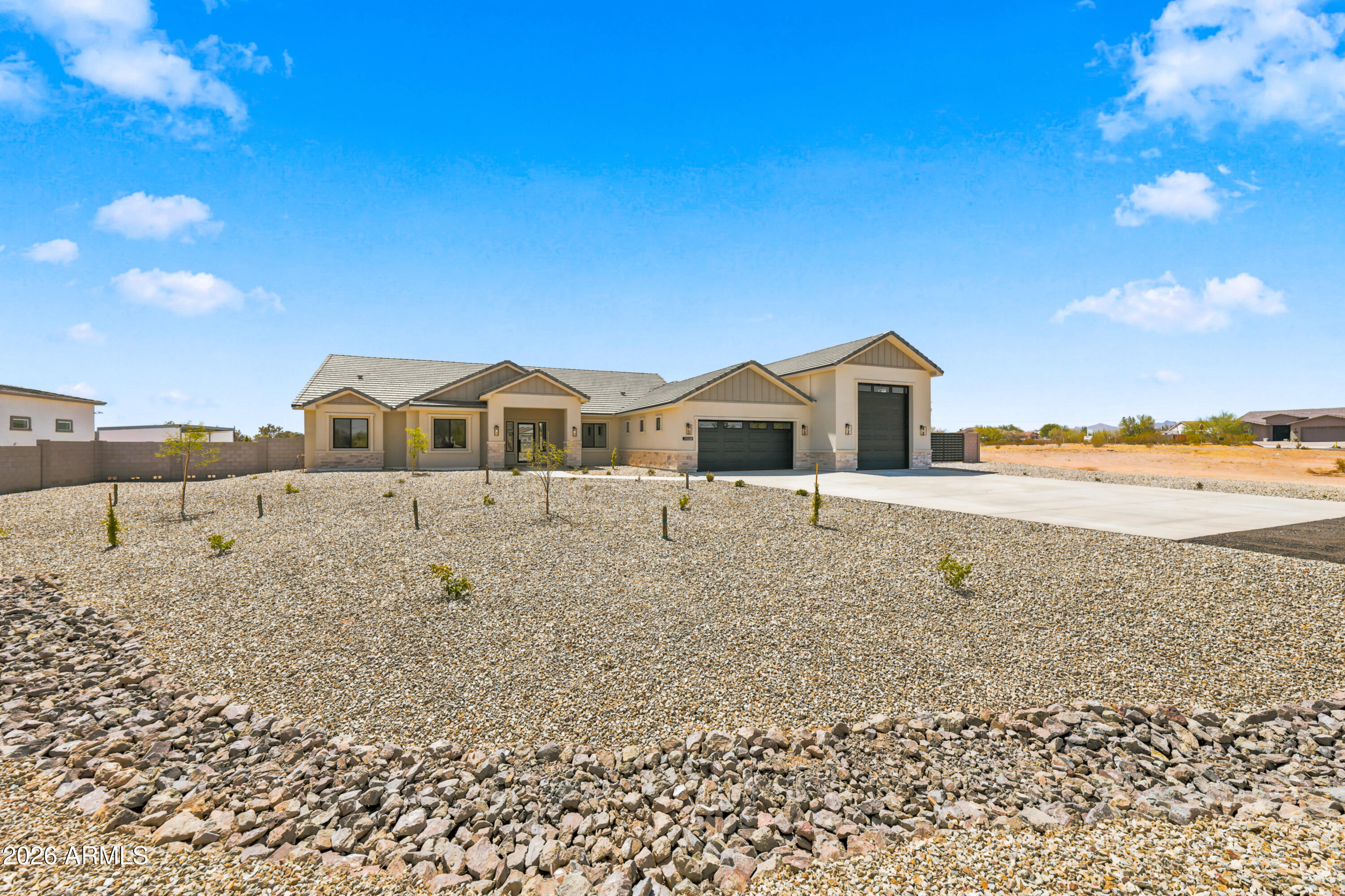 Welcome to your dream retreat on over an ACRE of Arizona desert! This brand-new 3,100 sq ft masterpiece by Galaxy Construction is built to impress -- featuring soaring 10-12 ft ceilings, 2x6 construction with spray foam insulation, and a jaw-dropping 51-ft deep RV garage big enough for your BIGGEST toys. Propane-powered luxury appliances, tankless water heater, gorgeous tile flooring, a chef's kitchen with island & walk-in pantry, and stunning mountain views. Paved roads, block wall fencing, extended concrete driveway, and a grand covered entry complete this one-of-a-kind horse property. Move-in ready -- just waiting for YOU!
