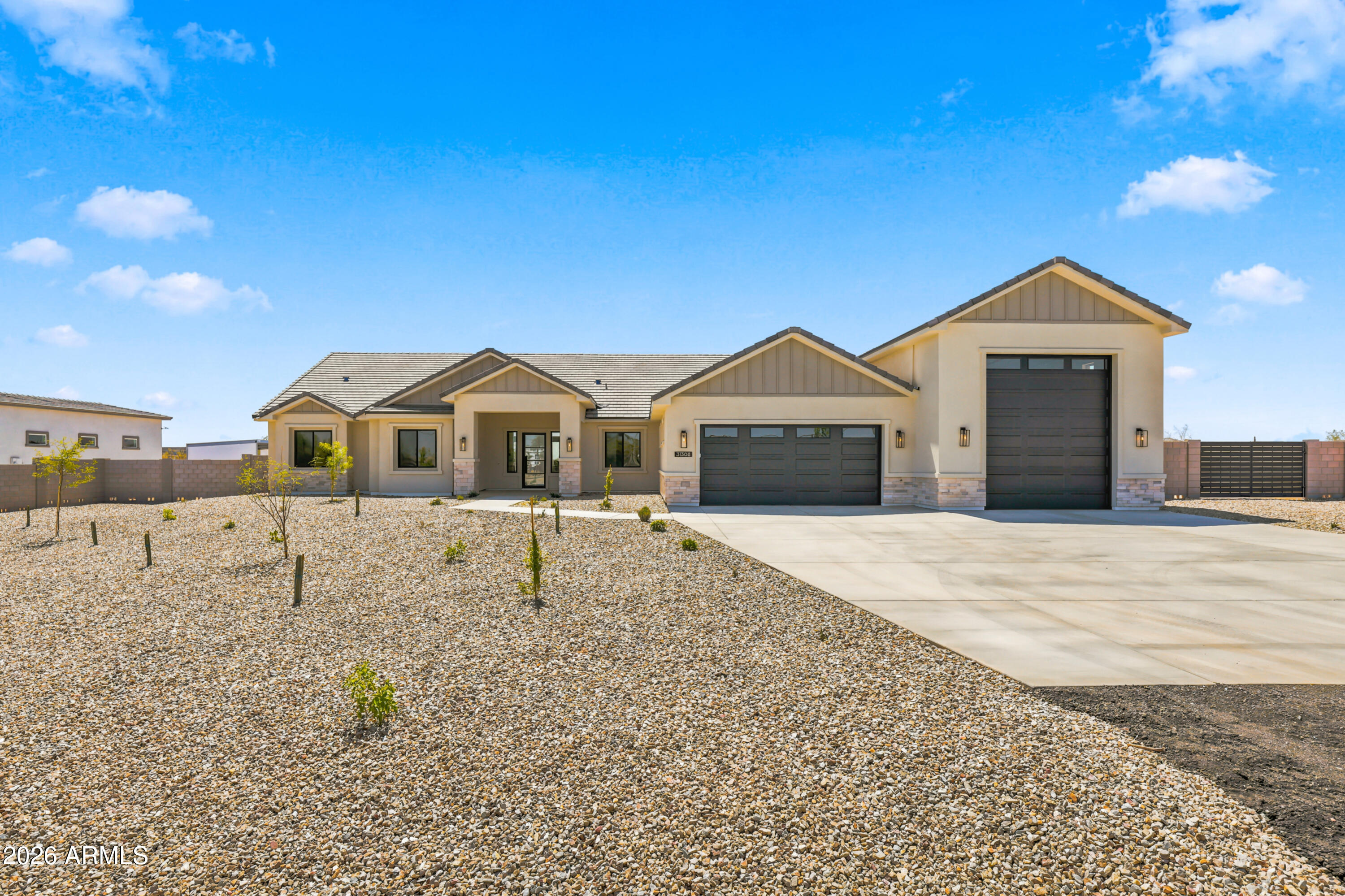 Welcome to your dream retreat on over an ACRE of Arizona desert! This brand-new 3,100 sq ft masterpiece by Galaxy Construction is built to impress -- featuring soaring 10-12 ft ceilings, 2x6 construction with spray foam insulation, and a jaw-dropping 51-ft deep RV garage big enough for your BIGGEST toys. Propane-powered luxury appliances, tankless water heater, gorgeous tile flooring, a chef's kitchen with island & walk-in pantry, and stunning mountain views. Paved roads, block wall fencing, extended concrete driveway, and a grand covered entry complete this one-of-a-kind horse property. Move-in ready -- just waiting for YOU!
