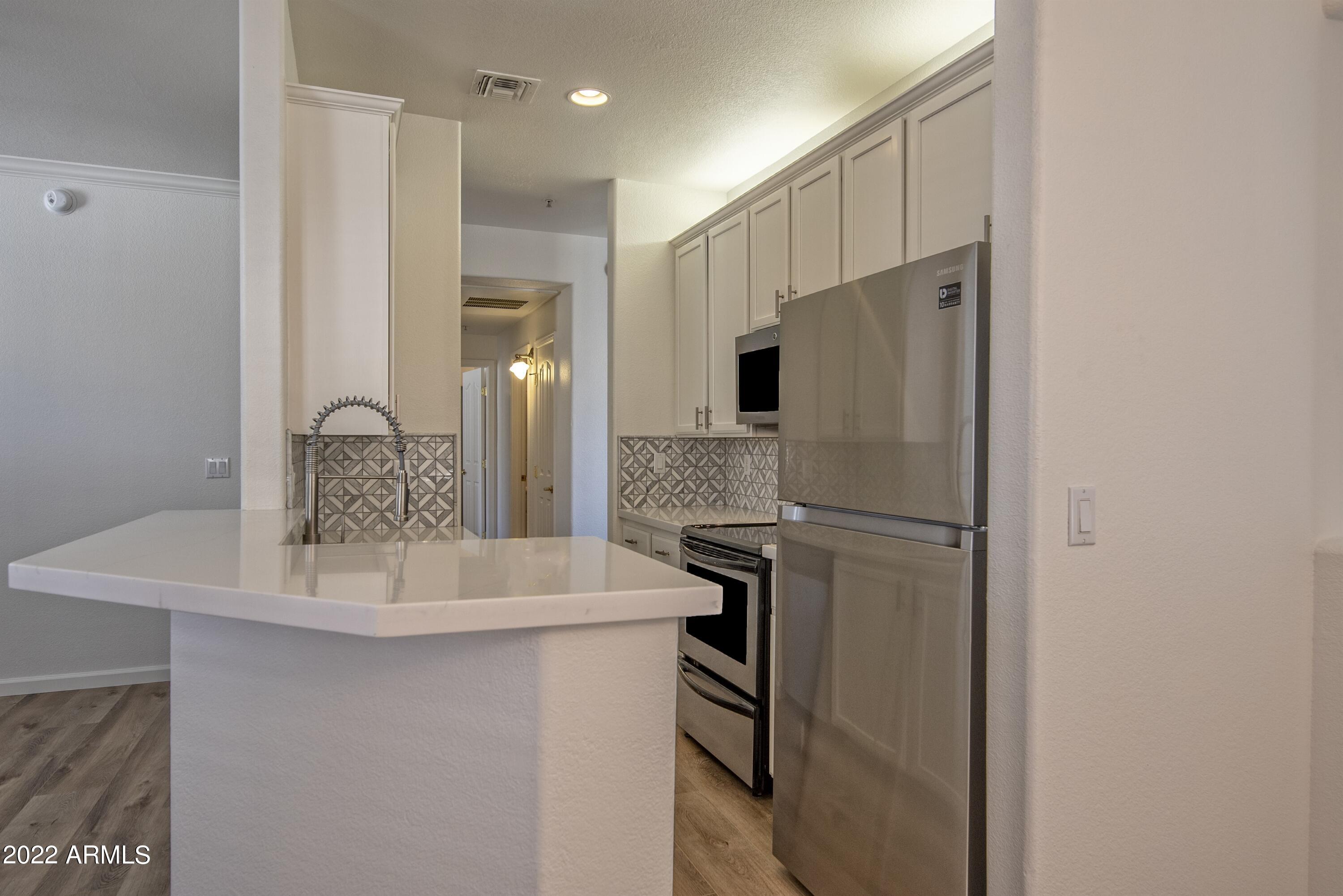 Welcome to this beautifully updated 2-bedroom, 2-bath condominium located in central Scottsdale. This prime corner unit offers exceptional privacy and catches the natural light from it's lofty position.  Step inside and discover a bright, open living space that went through significant remodel. The entire home features Sherwin-Williams Alabaster paint and stylish luxury vinyl plank flooring that is both sought after due to care and durability. The kitchen boasts of newer countertops, stylish backsplash, newer sink, garbage disposal, and stainless steel appliances--perfect for everyday living and entertaining. Both baths have been updated with newer tile, mirroring the quality achieved in the kitchen. Additional highlights include: Attached private garage. Ideal central Scottsdale location Both bathrooms have been updated with new tile, creating similar quality of kitchen remodel. Low-maintenance condominium lifestyle.  Ideal central Scottsdale location with easy access to shopping, dining, golf, parks, and major corridors.  Whether you're looking for a primary residence, a winter retreat, or an investment property, this turn-key condo located in this special gated community checks every box. Experience the perfect blend of modern updates and Scottsdale convenience!