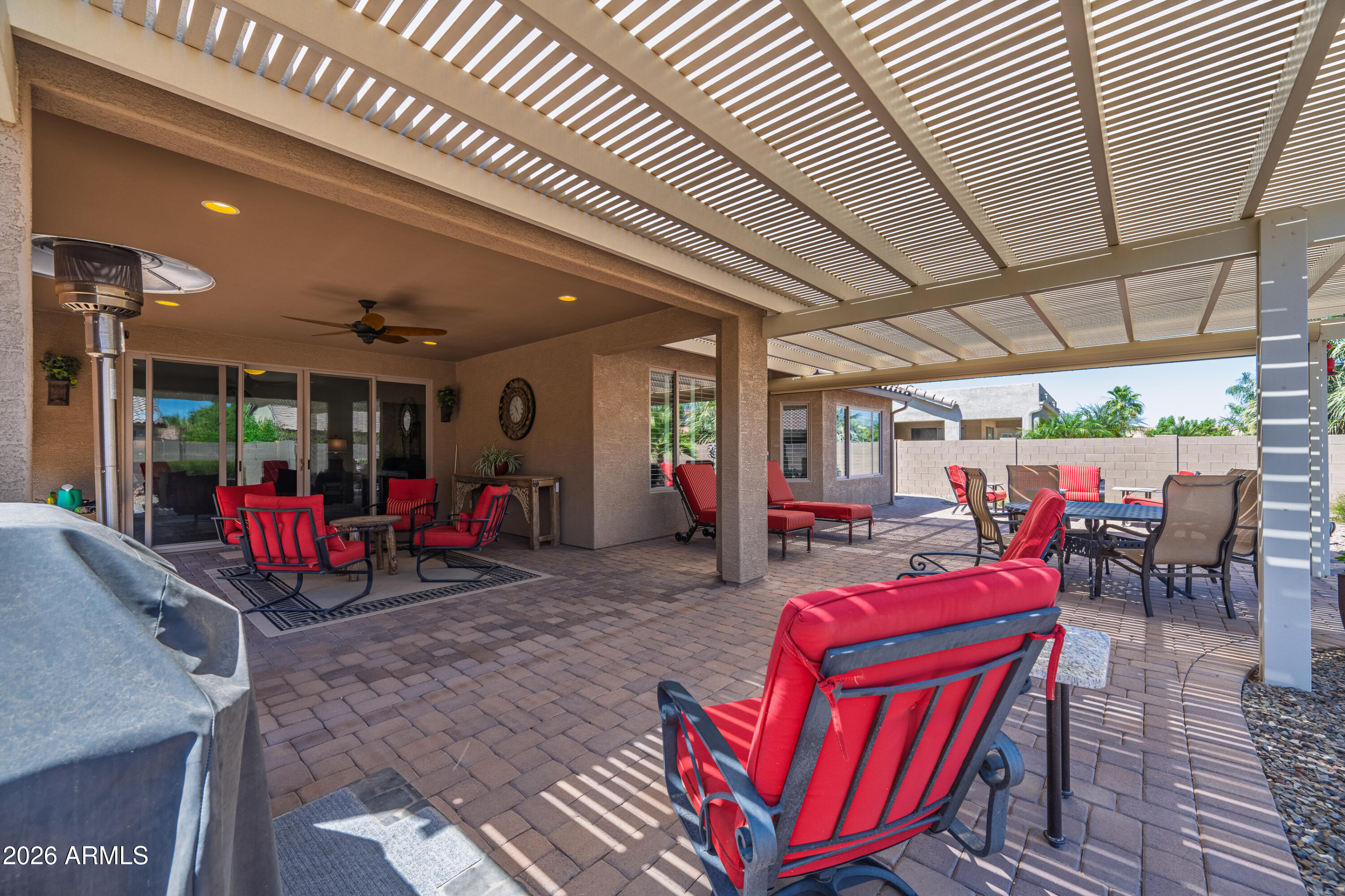 Exceptional Merano model is available partially furnished.  Also features a stunning patio pergola, perfect for entertaining and outdoor living. The deluxe kitchen is thoughtfully designed with built-in oven and microwave, a pantry, quartz countertops, and a 5-burner gas cooktop. The spacious primary suite includes a large bedroom extension and dual walk-in ''his and hers'' closets.  
Additional highlights include a private guest suite with a full bath and oversized closet, as well as an expanded 2.5-car garage with an additional 4-foot extension for extra storage or workspace. The home also features a new 5-ton HVAC air conditioning unit for enhanced comfort and efficiency. This home truly offers exceptional space, style, and functionality. See attached list of extras and furniture incl.