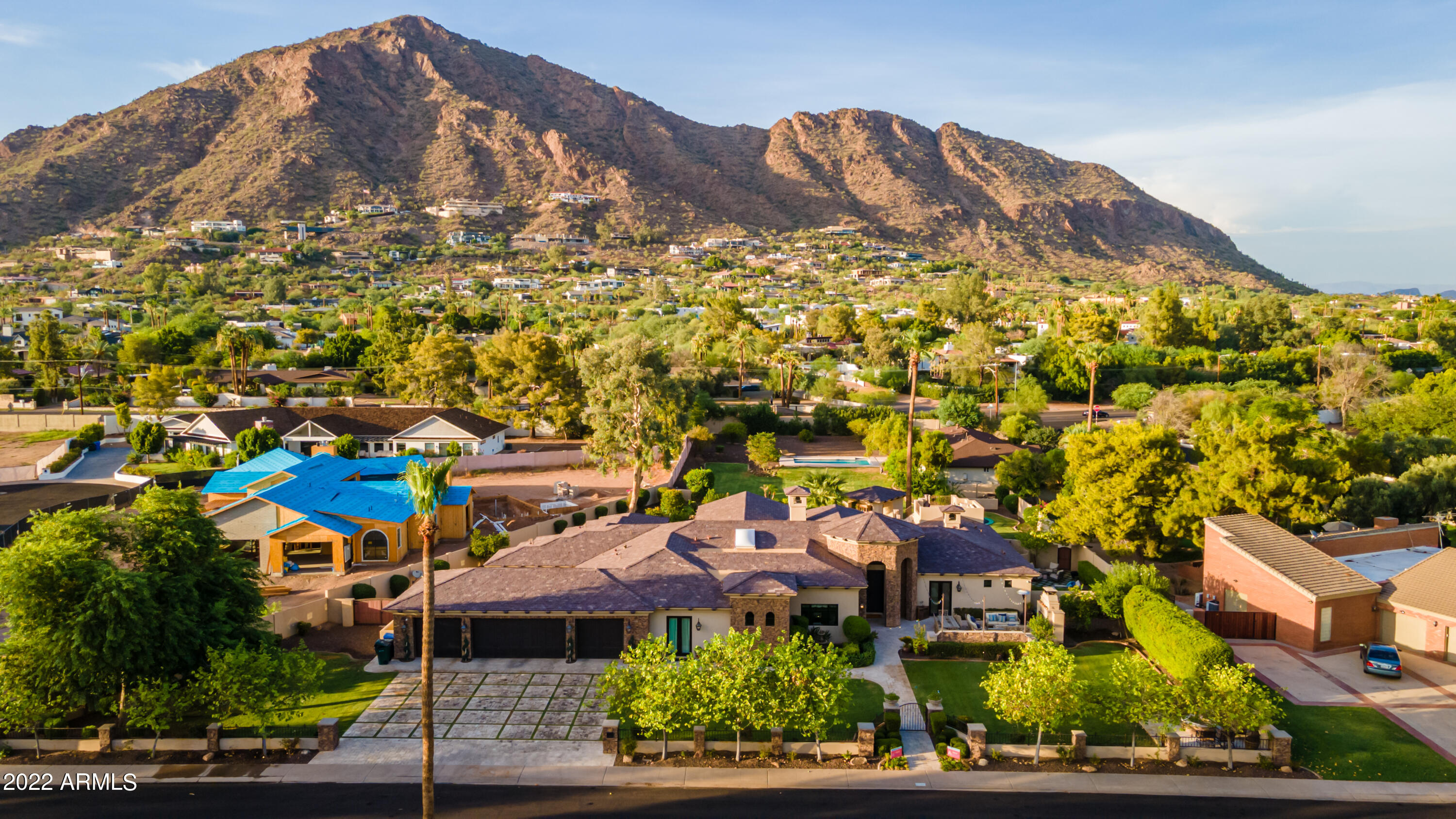 Unobstructed views of Camelback at this large lot high bone Santa Barbara transitional in Arcadia proper. Split floorplan with generous master amenities and office on one side, kids wing with kids living all en-suite with large closets and separate guest. Wine room, formal dining and game room in addition to open indoor outdoor formal living. Front home can be sold in conjunction with second guest house home and adjoining lot off 54th. Quiet street with no power lines, no alley and huge eat in kitchen and bar. Front yard al fresco dining and outdoor fireplace, back yard large north facing patios and resort style pool. Ideal entertaining home. Grass and turf details, lookout deck, newer build.
