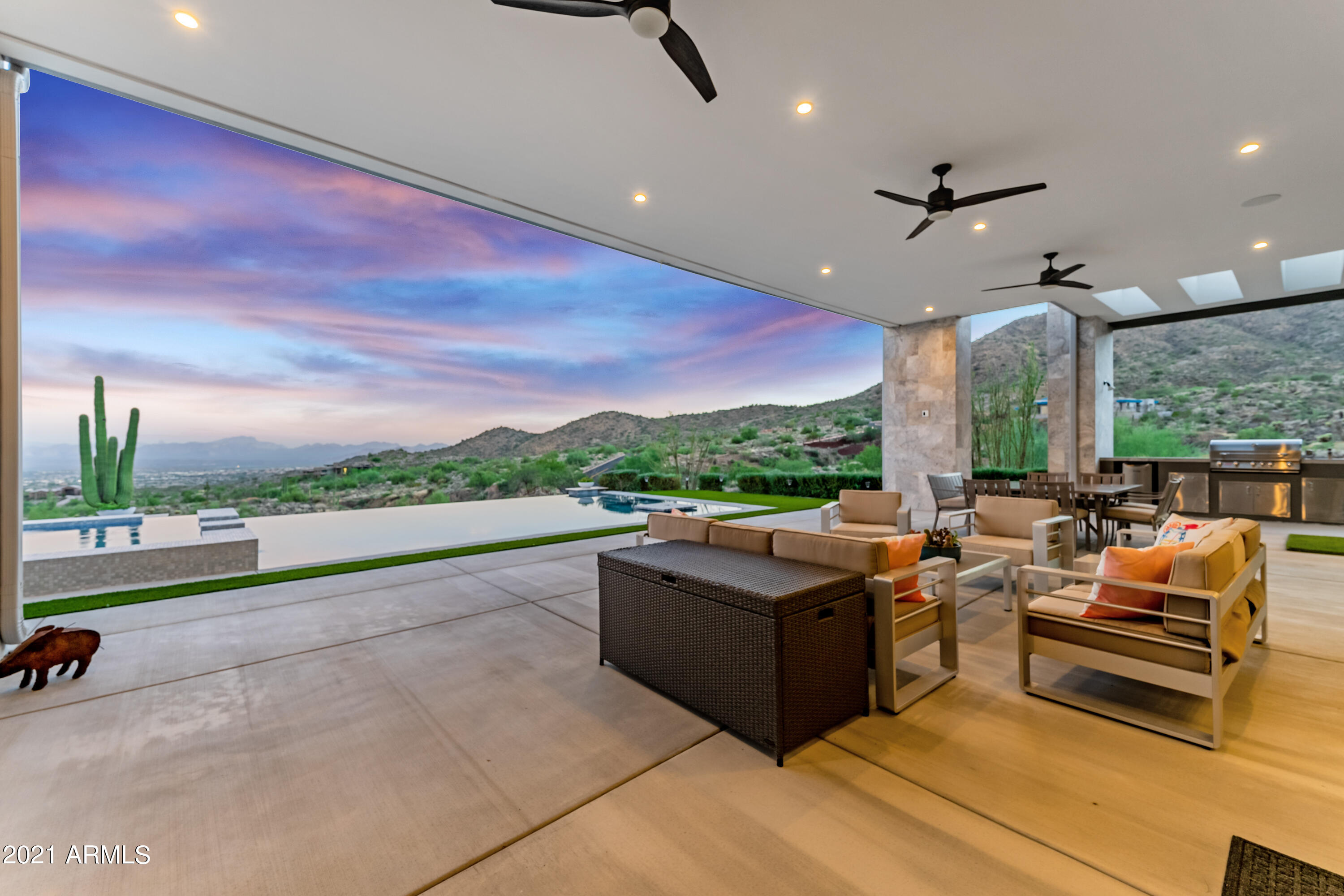 Stunning views in this single-story masterpiece. Every detail has been considered. The kitchen boasts modern European cabinets & drawers that electrically open with a simple touch. Huge island in kitchen for fun gatherings & a bar with window that retracts out of the way for patio service. The floating cabinets in the bathrooms are custom built with lots of storage. Designer tile in bathrooms and engineered hardwood in all other rooms. The rooms boast electric shades. Great Room has gorgeous fireplace & floating hearth. Huge fans in Great Room show off the 24' ceilings and windows. All bedroom closets have beautiful built-ins. Wet-edge, infinity pool & spa. But, the views you will enjoy from this home are truly breathtaking, including Four Peaks, Superstitions & the Fountain Hills fountain
