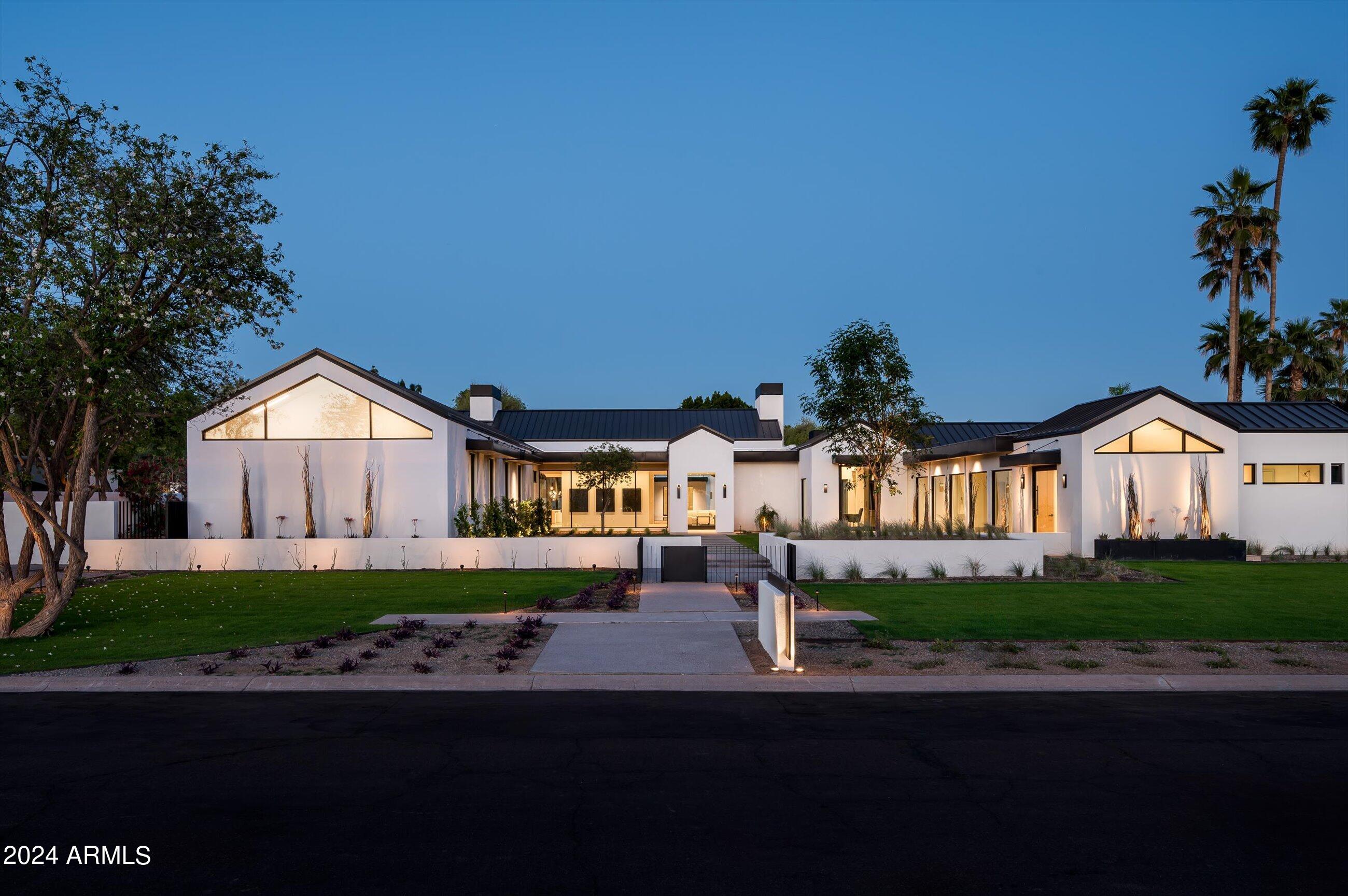 Seller willing to consider a seller carry at a 5.50% interest rate with 30% down and a 2 year balloon payment.  Nestled in the prestigious Paradise Valley Farms community of Scottsdale, this magnificent 7,915 square-foot modern masterpiece sitting on over an acre of land redefines luxury living in the heart of the Arizona desert. This new construction home built by TINKER Development and designed by Holly Wright Design, features 7,110 sq/ft in the main house and 805 in the fully detached guest house, and showcases architectural brilliance with its sleek lines, expansive windows, standing seam metal roof and cutting-edge design. From the rift oak cabinetry, to the European white oak flooring, to the 60+ slabs, and the recessed baseboards, every detail was thought of and no corner was cut making this home the epitome of modern opulence and sophistication.

Upon entering, you'll be greeted by a soaring foyer that leads to an open-concept living space with 24' ceilings in the great room. The expansive layout seamlessly connects the living room, dining area, and gourmet kitchen, creating an ideal environment for both intimate family gatherings and grand-scale entertaining. The chef's dream kitchen with fully appointed back kitchen boasts all Wolf and Sub Zero appliances with a 60" dual over range, Steam Oven, 3 dishwashers, both rocks and sonic ice makers, in wall water filler, Miele Coffee Maker, 36" fridge and 36" freezer in main kitchen and Sub Zero fridge with glass front in the back kitchen. 
The master suite is a private sanctuary, featuring a spa-like bathroom, his and hers fully appointed closets, and a 20' wall of automated retractable glass from the master shower that leads out to a private retreat with water feature. Three additional en-suite bedrooms in the main home and one in detached guest house offer luxurious accommodations for family and guests. Host movie nights in the state-of-the-art theater, wine enthusiasts will delight in the climate-controlled wine cellar, and fitness enthusiasts will appreciate the private gym. 

Step outside to an outdoor oasis and relax with the resort-style back yard featuring a 40'x40' zero edge pool and private spa, along with multiple covered patios with heaters and integrated misting systems, an indoor/outdoor bar area, as well as an outdoor kitchen/dining area with built in BBQ and Smoker, perfect for al fresco dining. Lush landscaping and breathtaking mountain views complete the serene ambiance. 

Control your home with ease using the latest in CRESTRON smart home technology. The system controls the AV, security and climate systems, shades, all lighting, mister systems, pool equipment, garage doors, driveway gate and the fireplaces. With a gated entrance, advanced security system, and meticulous landscaping, this property offers unparalleled privacy and peace of mind. 

Paradise Valley Farms is renowned for its exclusivity and tranquility. Enjoy proximity to upscale dining, shopping, championship golf courses, and scenic hiking trails. Top-rated schools are also nearby. This 7,915 sq/ft modern masterpiece is a rare opportunity to own a brand-new furnished luxury residence in one of Scottsdale's most coveted communities. Immerse yourself in the epitome of desert living, where sophistication meets serenity. Arrange a private tour today and make this extraordinary property your desert oasis.