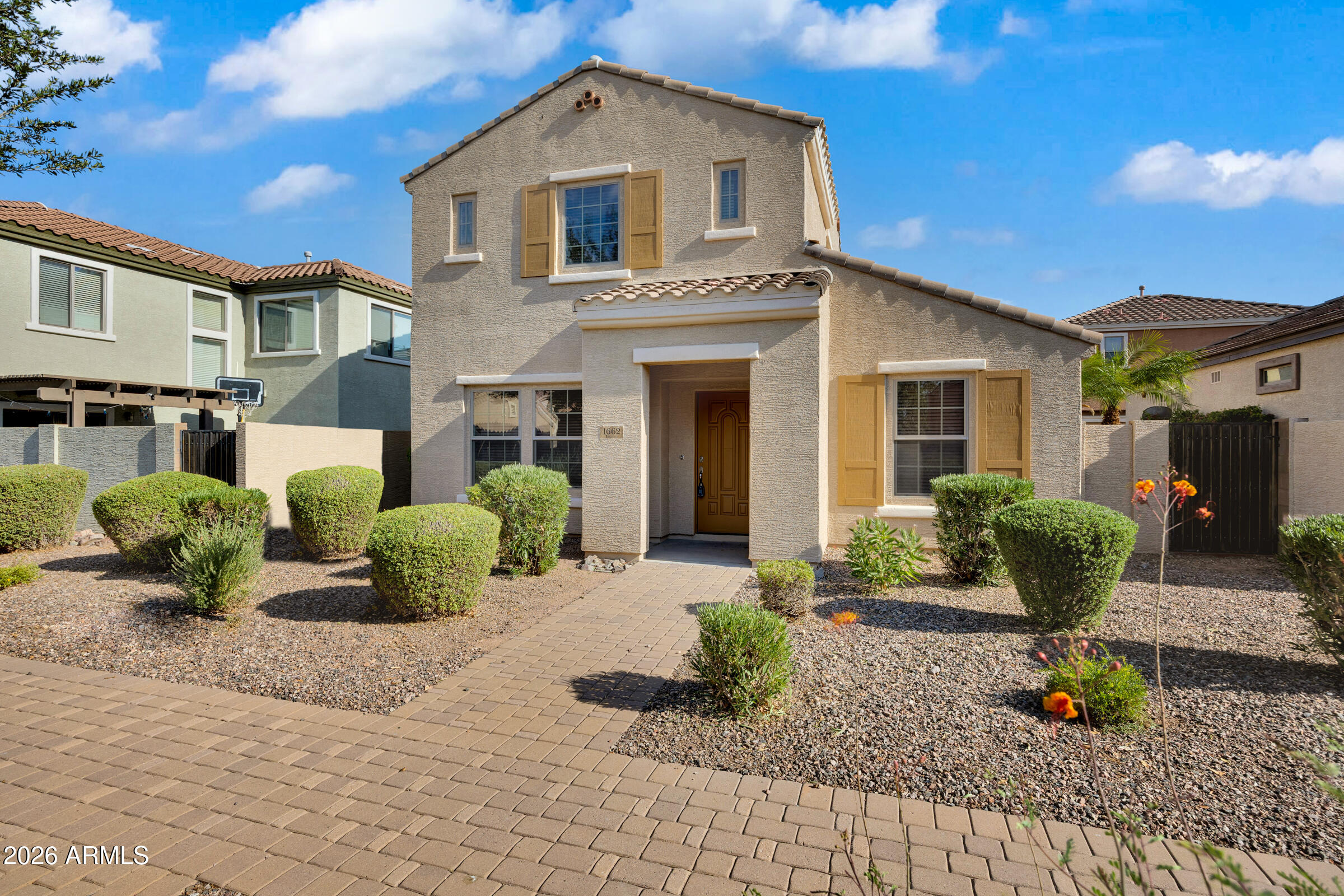 This move-in-ready home is nestled in the highly desirable master-planned community of Lyons Gate in Gilbert. Featuring a freshly painted interior and brand-new carpet throughout, as well as a newly painted exterior in 2024.  The downstairs boasts a bright, open-concept living area that flows seamlessly into a spacious eat-in kitchen complete with all appliances. Upstairs, you will find two bedrooms, two bathrooms, and a versatile loft area that serves as the perfect space for a home office nitch. Outside, the home features a cute, low-maintenance side yard, while the HOA takes care of all front yard landscaping for ultimate convenience. Living here grants you access to three sparkling community pools, endless playgrounds equipped with picnic areas and grills, and countless lush greenbelts winding throughout the neighborhood. This home offers incredibly quick access to the Loop 202, local grocery stores, and excellent dining, and is located less than two miles from the premier shopping and entertainment at SanTan Village Mall.