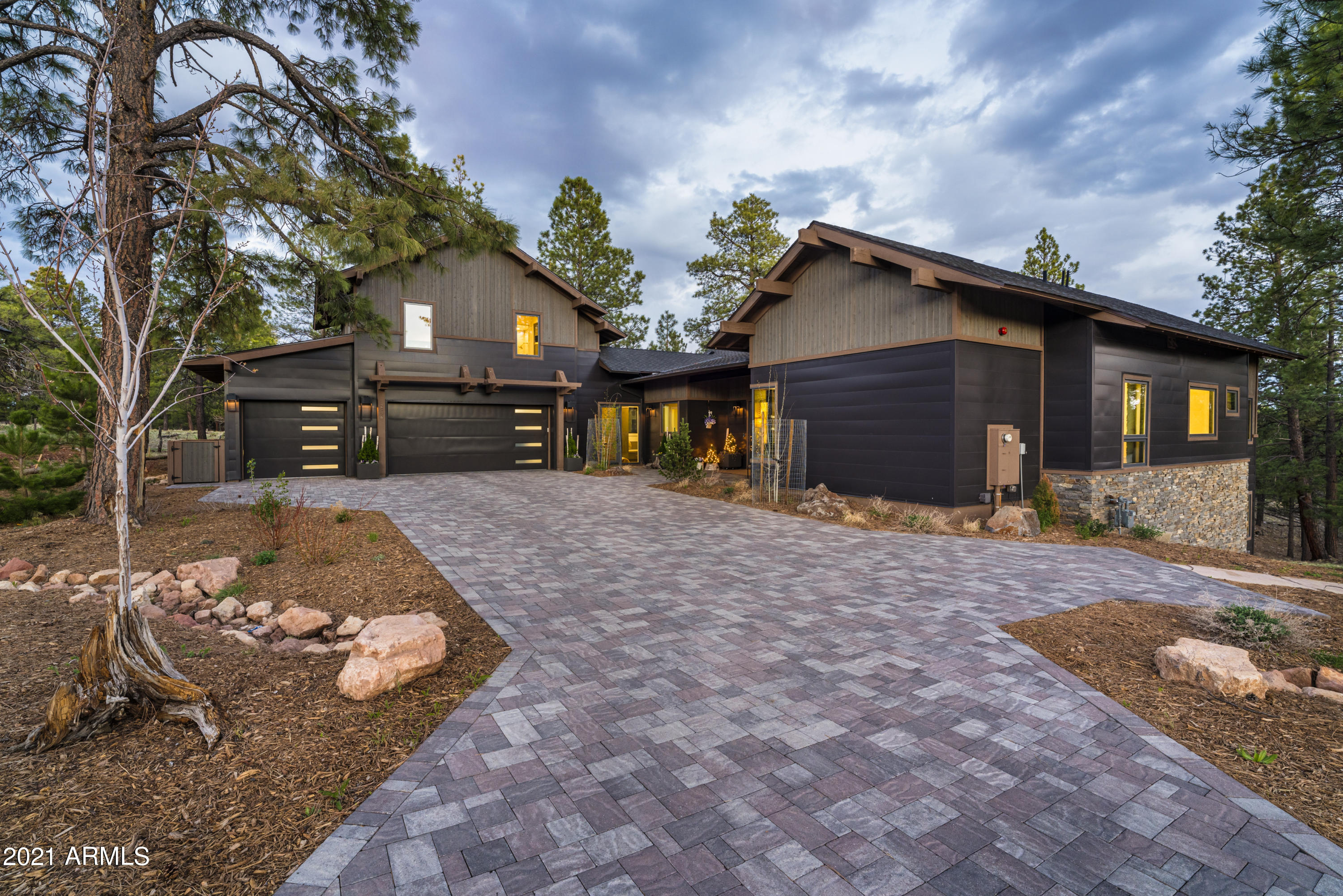 Take in the spectacular forest views from one of the best National Forest Lots within the Coconino Ridge enclave. This Sitgreaves Coconino Ridge floorplan is 4,681 sq. ft. and features many upgrades and customizations. The living room includes tongue and groove ceiling with exposed wood beams, a gas fireplace, wood flooring throughout and a large pocketing door system leading out to the partially covered deck with a built-in Big Green Egg BBQ. The living room and dining area blend seamlessly into the kitchen which features an island with separate veggie sink, tons of cabinet space, 48" Sub Zero refrigerator, 2 ovens, and a 48" Wolf Range with custom stove backsplash. The kitchen leads into a custom butler's pantry with a separate wine refrigerator and shelving for beverage glasses. 
The spacious Master Bedroom is located on the main level and includes a custom cabinetry entertainment area, wood flooring, and roomy walk-in closet. The Master Bath has a large soaker tub, hers and hers vanities, a makeup vanity and a separate shower. 
There is also an additional en-suite Guest Bedrooms on the main level.
The homes lower-level walk out basement is the perfect guest quarters with a full kitchen, living room, bedroom and full bath equipped with a soaker tub, separate shower and makeup vanity. Sliding glass doors lead you out to the private covered patio, just feet from the Coconino National Forest.
The home also features an upper-level bonus room with full bathroom, perfect for an office or kids gaming area.
Additional features include 2 laundry rooms, a large dog run with synthetic grass, a custom range hood matching the living room fireplace finish, exterior security cameras, 3 car garage, and a mud room. This parcel includes ½ of the adjacent lot next door and approved plans are available for an addition of an office or casita separate from the house. 
The furnishings are available on a separate bill of sale and you could be enjoying the serenity of Pine Canyon this summer!