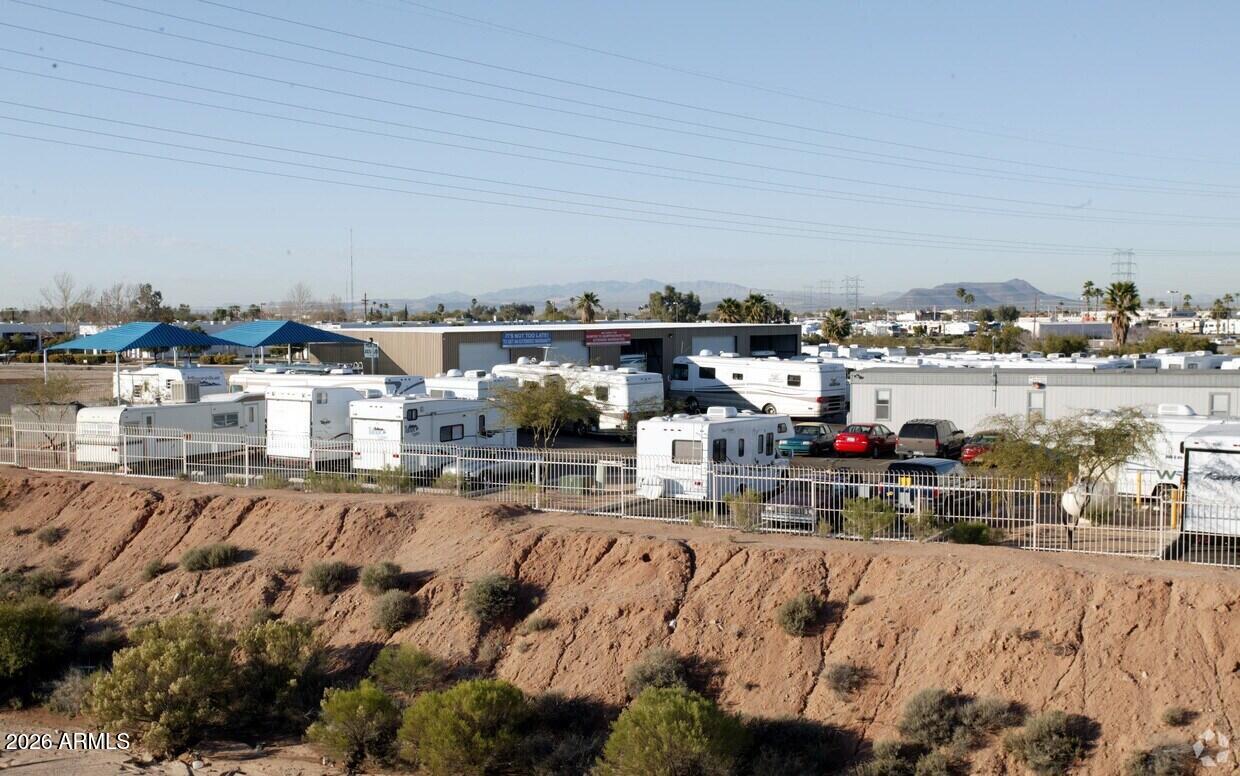 Currently operating as RV Sales, Auto Sales and Service Center.

Approx. 2.4 Acres of fenced lot, 5,000 SF Service Building with 14 foot door heights and 1200 SF Modular Office/Sales Building.  

Great Freeway visibility to I-10.