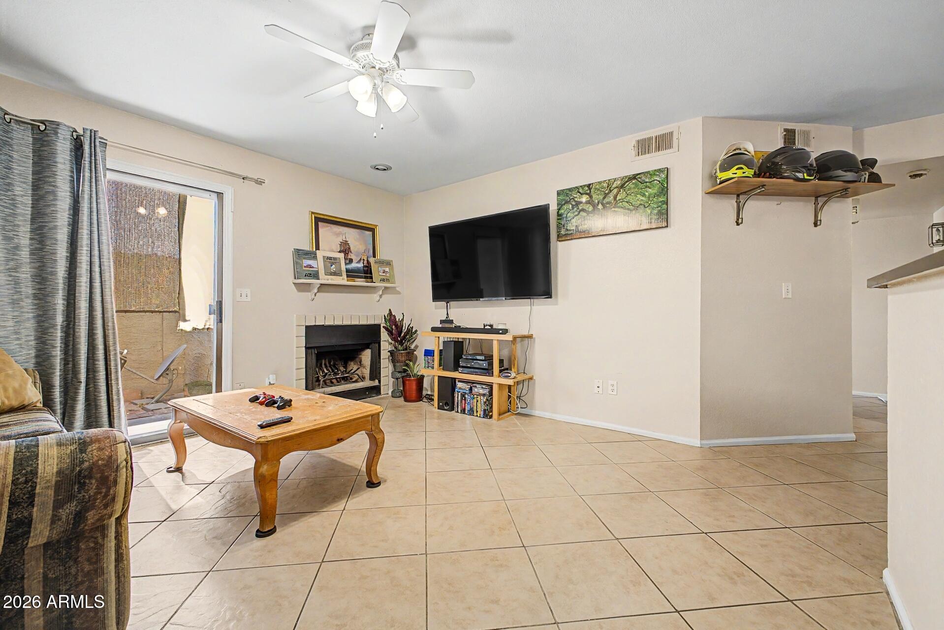 Move-in ready ground floor 2-bedroom, 2-bathroom condo with a private patio and no stairs. The open layout features a wood-burning fireplace and inside laundry with a new washer and dryer. New water heater recently installed. Two assigned parking spaces included, conveniently located just steps from the front door. Situated in a clean, well-maintained community with a sparkling pool. Outstanding location with easy access to major freeways, shopping, dining, and schools. Priced to sell!