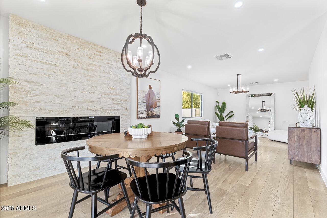 Welcome to this beautifully remodeled home located in the highly desirable Tolsun Farms, offering space, freedom, and luxury finishes with NO HOA. This spacious property features 3 bedrooms, 2.5 bathrooms, and 1,953 square feet of living space, including two separate living rooms that provide flexibility for entertaining, relaxing, or hosting family gatherings. From the moment you step inside, you'll notice the upgraded finishes throughout, including durable laminate wood flooring, designer lighting, and a stunning floor-to-ceiling stone fireplace that anchors the open-concept layout and creates a warm yet modern focal point.The chef's kitchen is truly the heart of the home, showcasing custom natural wood cabinetry paired with beautiful leathered marble countertops. Stainless steel appliances, double wall ovens, a farmhouse sink, pot filler, and a large waterfall-edge island built for entertaining. 
The combination of rich wood tones and natural feel while maintaining warmth and functionality. 
The primary suite offers a spa-inspired bathroom with custom tile work and quality finishes, while the additional bedrooms are generously sized and filled with natural light. An indoor laundry room adds everyday convenience. 
Situated on an expansive 17,891 square foot lot, this horse property is fully enclosed with block wall for added privacy and includes a 2-car garage, RV parking, and a two RV gates, providing exceptional flexibility for trailers, recreational vehicles and additional storage. 
The backyard features a large, covered patio, extended paver seating areas and a grassy yard perfect for family get-togethers, celebrations, and outdoor entertaining. 
Located in the cozy town of Tolleson, residents enjoy access to local restaurants, shops, community events, and nearby police and fire departments, combining small-town charm with everyday convenience. With luxurious finishes, generous living space, and the freedom of farm community living, this property is a rare opportunity you don't want to miss.