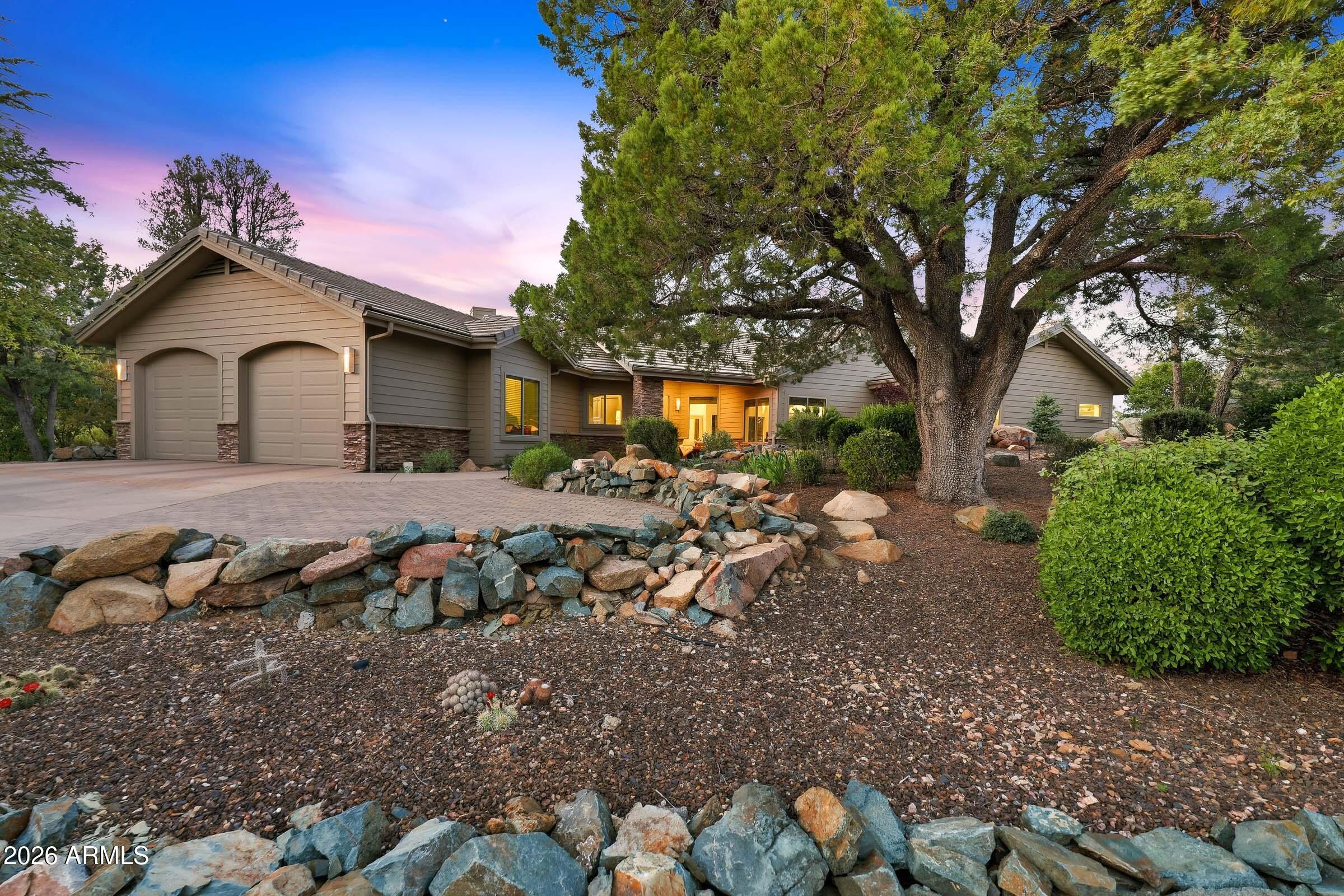 Hidden within the cool pines of the gated Sierra Timbers at Hassayampa, this single-level estate represents a rare convergence of master-class construction and fresh, yet sophisticated design. A total 2025 renovation by TLC Construction and Amy Jacobs Interior Design, the home is a study in Modern Classic aesthetics with clean lines balanced by rich, organic textures.
The panoramic views throughout the home enhance the architectural journey as it begins in the front lifestyle gallery room, where a stunning coffered beamed ceiling anchors a space designed for hosting. A custom beverage/coffee bar serves as the centerpiece for cocktail hour, flowing naturally into the front piano room. The kitchen is a chef's sanctuary, featuring a massive Taj Mahal quartzite island and a remarkable   MORE. atone culinary alcove with an integrated hood. Custom white oak cabinets by MKC Woodworks and Monogram appliances reflect a high performance with sleek design philosophy.
The floor plan was strategically optimized to frame the views.  From the family room and split primary suite, the panoramic vista spans the twinkling lights of downtown Prescott to the iconic silhouette of Thumb Butte, reaching as far as the snow-capped San Francisco Peaks on the horizon. The primary wing is a private retreat, complete with a spa-inspired bath that rivals any luxury resort.
Anchored in the renowned Capital Canyon Golf community, this half-acre cul-de-sac retreat features custom white-washed stone mortar accents and a private patio for sunset viewing. For the discriminating buyer who understands the nuance of a high-quality build, this is a turnkey designer masterpiece in the heart of Prescott's most prestigious enclave.