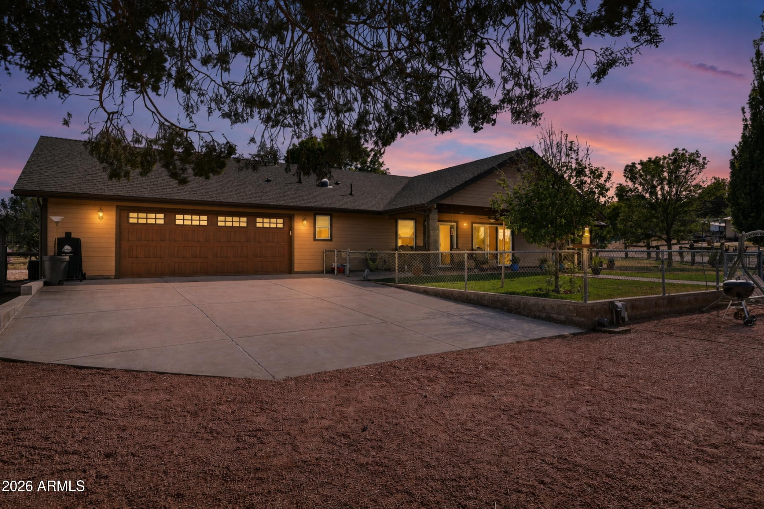 Welcome to this beautifully maintained 3-bedroom, 2-bathroom home situated on 1 acre in the highly sought-after Round Valley neighborhood of Payson. As you arrive, you'll be greeted by a charming fenced courtyard, an ideal space to relax and enjoy Payson's wonderful four-season weather. Inside, you'll find durable concrete flooring throughout, complemented by granite countertops in both the kitchen and bathrooms. The kitchen features stainless steel appliances and plenty of workspace for cooking and entertaining. The spacious primary suite offers a walk-in closet with custom shelving and a beautiful walk-in shower. Both guest bedrooms are equipped with Murphy beds, providing flexibility for guests, hobbies, or a home office. Step outside to a backyard designed for both enjoyment and functionality. This horse property offers ample room for animals, recreation, RV parking, or future projects. Unwind after a long day in the salt water hot tub while taking in the peaceful surroundings. A fully fenced grass area provides a perfect place for pets or outdoor gatherings. Additional features include a greenhouse, a charming old barnwood shed, and a separate storage shed for all your tools and equipment. Car enthusiasts and hobbyists will appreciate the impressive 4-car drive-through garage, complete with attic storage above, offering abundant space for vehicles, toys, and extra storage. This exceptional property combines country living with modern comforts, all within one of Payson's most desirable neighborhoods.