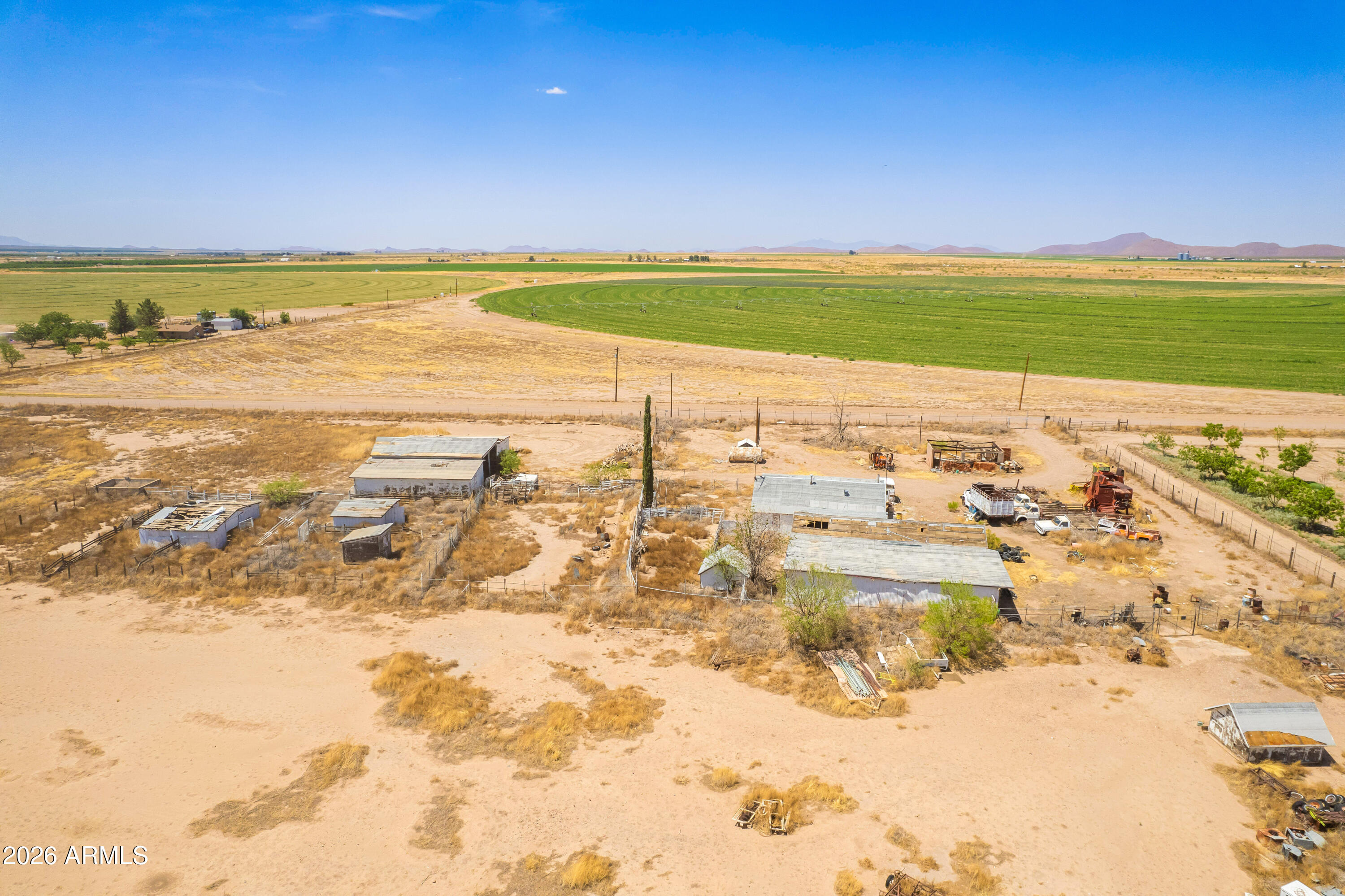 Expansive 78.86-acre property in Elfrida, AZ offering incredible opportunity for farming, ranching, or future development! The land is level and ready to be put to use, making it ideal for agricultural operations or investment. The property includes a 3-bedroom, 2-bath home in need of repair, presenting potential for renovation or replacement. Multiple outbuildings, including large storage structures suitable for equipment, tractors, and agricultural use, provide added value and functionality. Property also features two wells (condition to be verified by buyer). Endless possibilities with this versatile acreage--bring your vision to life! All information deemed reliable but not guaranteed; buyer to verify all facts and conditions.