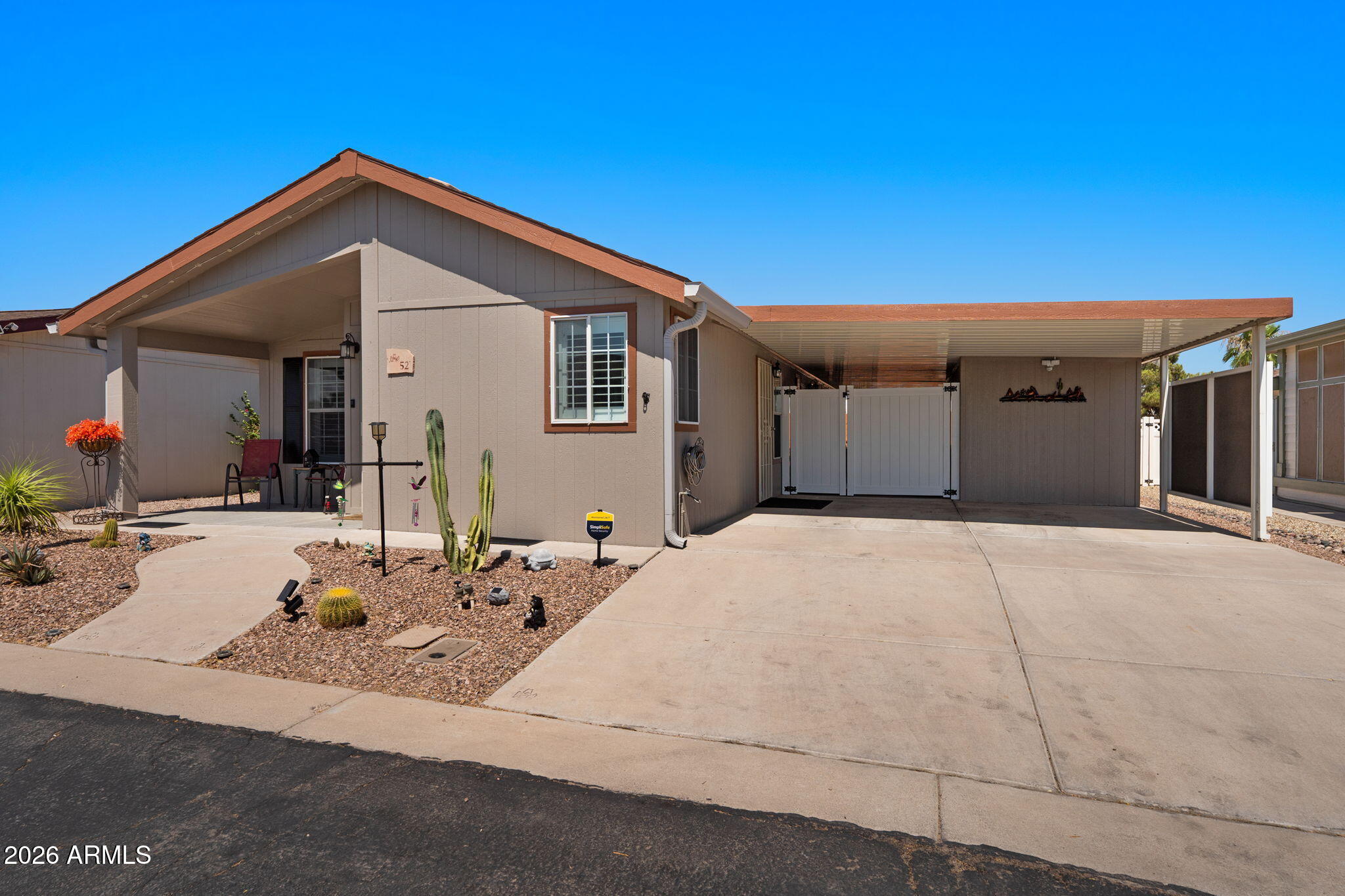 ACTIVE ADULT LIVING AT ITS FINEST! This is NO ORDINARY HOME in an average 55+ COMMUNITY. It is so much more! This might be the single best opportunity in the EAST VALLEY. The amenities are off the charts: ROOF is 7 years old, AC unit is 2 years old, CULLIGAN HOME WATER SYSTEM is a year old, R/O under the sink, STAINLESS STEEL appliances in the kitchen that are 2 years old, GAS STOVE, BOTH FRIDGES STAY, 3 BEDROOMS and 2 FULL BATHROOMS, WORKSHOP with power and water, ARTIFICIAL GRASS in the back, covered sitting area on the side of the home with a mounted TV that the owner is willing to leave, COVERED 2 CAR CARPORT big enough for a large truck plus additional space for golf cart that can be put behind the vinyl wall, and LVP flooring throughout the home. A must see...come check it out today!
