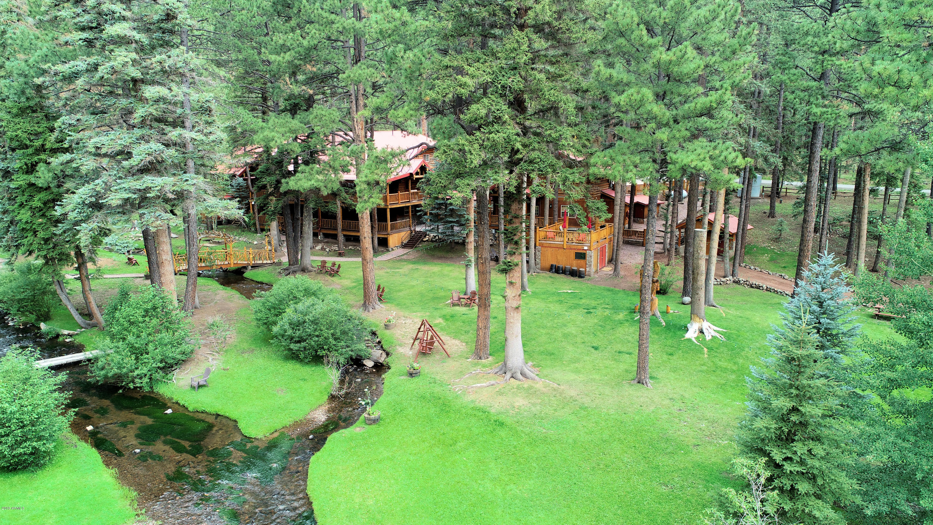 The Little Colorado River runs through this special property. The property is operated as a venue & nightly rental. This listing includes all 4 acres of the property, a 9 bedroom, 9.5 bath Lodge; a 2 bedroom, 2 bath cabin with an approximate 400 sq ft deck (above a storage room for venue chairs & tables); 2 outdoor (1 wheelchair friendly) bathrooms, a 5 bedroom, 3 bath cabin, 2 one bedroom/loft/1 bath cabins & enough land to build another cabin (assuming required permits from the county). The cabins were built with large natural logs, have multiple fireplaces, & large outdoor decks overlooking the property. The grounds have a fire pits & horseshoe pits and 2 bridges.  Go to: www.greerredsetter.com for more details This property is special! Originally a world renowned bed and breakfast, the property is now a wedding venue, reunion spot, business, church and organizational retreat and a nightly rental. Some financial information is available to qualified buyers, who sign the confidentiality agreement. Extensive remodeling has been done since purchased in 2013. Opportunities for Buyer to Consider: 1 - continue to operate as is with a property manager; 2 an Owner/Operator has potential to improve cash flow (versus having a property manager); 3 - return the Lodge to a bed and breakfast with likely increased occupancy and cash flow; 4 - expand capacity by building another cabin on the North end of property. Buyer must honor 2021 rental commitments in place as of the date of closing.