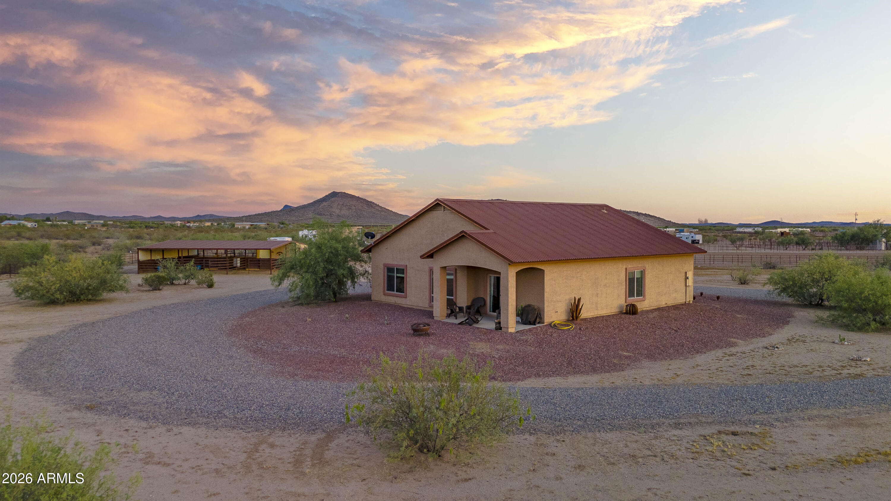 Custom-built home on 10 fully fenced acres offering endless possibilities and breathtaking desert views. This 3-bedroom, 2-bath home features a gourmet kitchen with Knotty Alder Kropf cabinetry, granite countertops, and a spacious walk-in pantry. The bright open floor plan is highlighted by large windows that perfectly frame the surrounding landscape. Equestrian-ready property includes a 5-stall barn with covered walkway, tack room with water and electricity, perimeter fencing, and cross fencing. A private well services the additional 5-acre parcel, while the home is connected to a 50/50 shared well. Plenty of room to create your dream horse facility with convenient access to riding trails and nearby equestrian events.