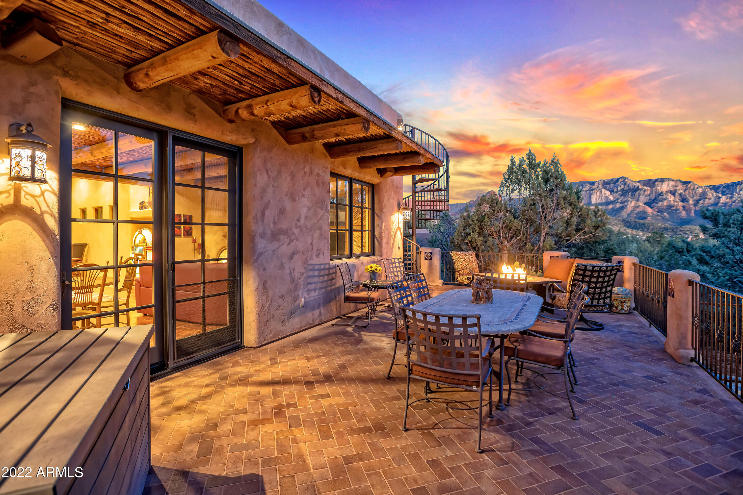 Step through Gates into a Taos Hacienda in Uptown offering SERENE PRIVACY backed by NATIONAL FOREST and TOWERING IN YOUR FACE RED ROCK VIEWS. Exquisitely appointed: Viga Beam ceilings, hand carved doors, Santa Fe Barnwood Cabinets, Cranberry Viking Appliances, 4 Car Garage spaces, Stargazing Rooftop Deck, Hot tub, Intricate tile & brick work, hand painted sinks, 4 fireplaces.  Nestled on .86 acres, enjoy coffee or wine on multiple patios, entertain in the Great Room & take in a game of billiards, serve up the perfect dinner w/ your built in BBQ. 3 Bdrms, 3bths in main home ALL ON ONE LEVEL w/ 4 steps down to guest suite. Detached 2 car garage has a ¼ bth and sink and could be converted to a separate casita. Fully fenced massive dog run.  MUST BE SEEN IN PERSON TO APPRECIATE!